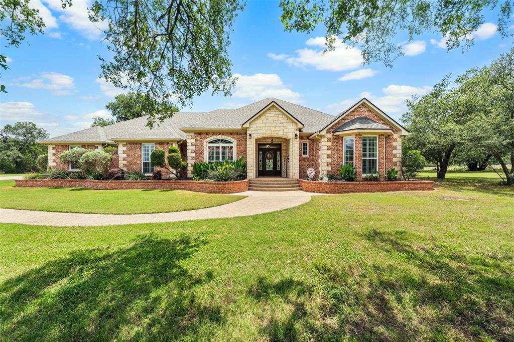 Welcome to this stunning Crawford, TX home situated on 1.89 acres in the sought-after Three 17 River Oaks subdivision within Crawford ISD. Offering 4 bedrooms, 3.5 bathrooms, a spacious game room, and a 3-car garage, this beautifully designed home combines comfort, functionality, and timeless style across 3,292 square feet. Step inside to an open-concept floor plan featuring tall ceilings, a cozy fireplace, and a bright formal dining area that creates the perfect space for everyday living and entertaining. The kitchen is designed to impress with a Jenn-Air gas cooktop, built-in oven, granite countertops, custom cabinetry, and abundant storage space. The private primary suite offers a relaxing retreat with a spa-inspired bathroom featuring a soaking tub, walk-in shower, dual vanities, and oversized walk-in closets. Upstairs, the game room provides the perfect hangout space and could easily serve as a 5th bedroom if needed. Additional features include plantation shutters, tile flooring throughout the main level, and thoughtful attention to detail throughout the home. Outside, enjoy a fenced yard for pets, sprinkler system, storage building, and beautiful brick and stone exterior surrounded by peaceful, park-like scenery. Situated just minutes from schools & Tonkawa Falls, providing easy access to community life! Whether you're hosting guests or enjoying quiet evenings under the Texas sky, this property offers the perfect blend of luxury, space, and country living in the heart of Crawford.