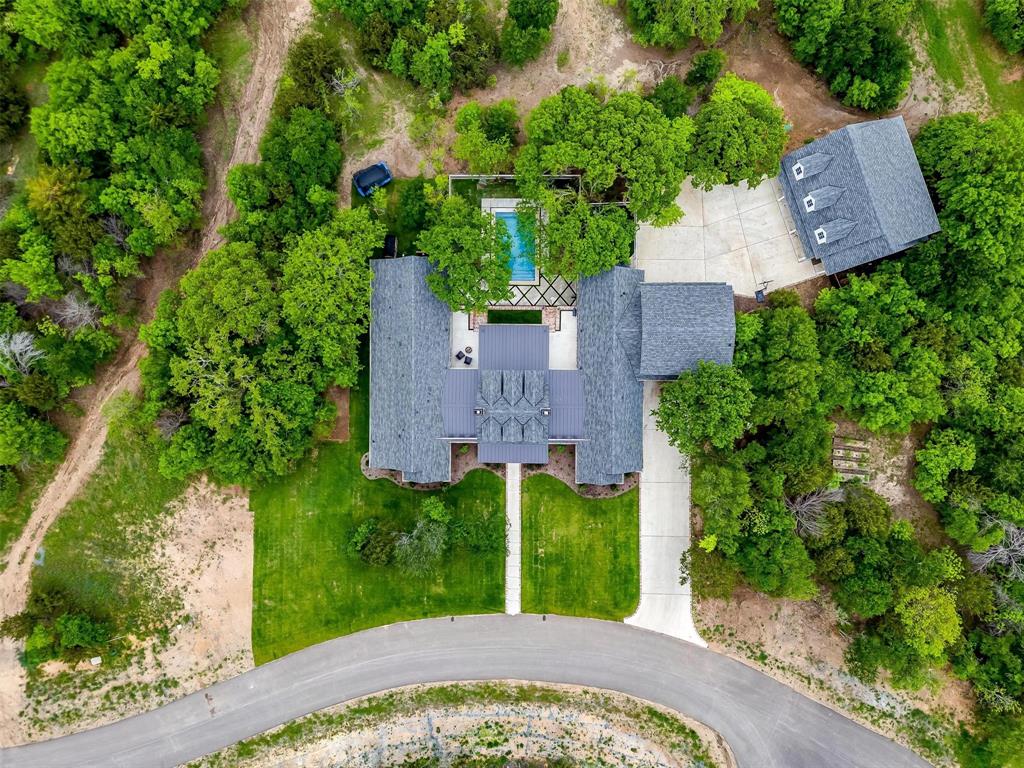 A masterpiece of stunning design located in one of the best pockets of Aledo ISD off coveted Jenkins Road. Sitting on a densely treed 2 acre lot in the newly developed, upscale Aledo River toward the end of the one street cul-de-sac. The Martha’s Vineyard architectural style combines extravagant luxury with timeless charm. The 5066 sqft main home offers 4 bedrooms & 3 and ½ bathrooms. An attached guest apartment (or office) is upstairs over the porte-cochere consisting over 1000+ sqft with kitchen, laundry capability and separate entrance. In addition the detached 6 car garage (3 tandem stalls) offers 857 sqft of unfinished space above for future needs or storage. The quality of the finish out & the thoughtful attention to livability is evident inside & out. The location offers privacy and seclusion while being in one of the most accessible, convenient parts of Aledo. Close to parks, an extensive hike & bike trail + Friday night lights. Fantastic opportunity for luxury & convenience.