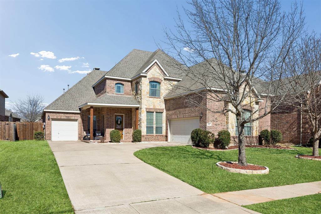 Buyers searching for homes in Keller with premium upgrades and an established neighborhood setting will find an exceptional opportunity in this beautifully updated residence. Located near Old Town Keller, this 3,888-square-foot property serves as a compelling new construction alternative, showcasing a spacious 2-story layout with 4 bedrooms, 3.5 baths, and structured spaces that naturally accommodate a work from home lifestyle. Elegant hardwood flooring flows seamlessly through the main level, connecting the dedicated private office and formal dining room to the central living areas. The expansive kitchen features granite countertops, classic oak cabinetry, a large central island with storage, a walk-in pantry, and a breakfast bar that overlooks the casual dining nook. In the main living room, tall windows fill the space with natural light while a central fireplace serves as a sophisticated focal point. Positioned on a separate wing for optimal privacy, the primary suite features a generous walk-in closet and a resort-style bath complete with dual sinks, a jetted tub, and a separate shower. The thoughtful layout includes a second downstairs suite with a private ensuite bath, while the upstairs level hosts 2 additional bedrooms sharing a Jack and Jill bath, a versatile loft, a dedicated media room prewired for sound, and a flexible bonus room. Outside, a welcoming front patio and a spacious backyard patio provide comfortable areas for outdoor relaxation, framed by mature trees and established landscaping that newer developments often lack. This move-in ready home offers convenient access to US-377, major employment centers, regional shopping venues, and local dining, all while being situated within the highly sought-after Keller ISD boundaries.