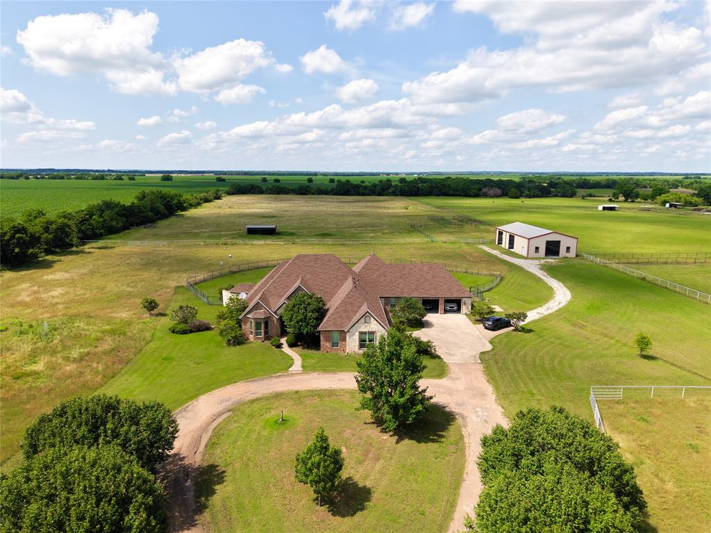 You don’t leave the city just for more space—you come here for a different way of living. Set on ~15 private acres in Pilot Point, this property offers a rare blend of privacy, comfort, and long-term potential in one of North Texas’ fastest-growing corridors.

The home features 4 bedrooms, 5 baths, and expansive, light-filled living spaces centered around a functional, inviting kitchen. The primary suite serves as a private retreat, while the remaining bedrooms offer flexibility for guests or family. Outdoors, the property is built for both lifestyle and function—a resort-style pool with waterfall and slide, two large pastures with loafing sheds, and a 2,300 SF shop ideal for storage, hobbies, or future use.

Positioned near the proposed Pecan Creek development, the property benefits from its location within a rapidly developing area of North Texas.