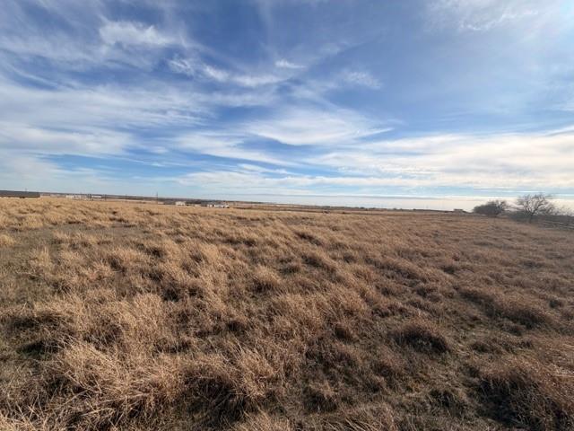 Beautiful 4.1-acre interior lot located just approximately 500 feet off the main road, offering privacy with easy access. The property is fully cleared of trees and ready for development, with perimeter fencing already in place. Gently rolling open pasture provides an ideal homesite with wide-open views and plenty of space for a custom home, barndominium, or small ranch setup. Electric is available nearby with utility poles along the road. Peaceful rural setting while still conveniently located to town amenities. No floodplain, no city restrictions, and plenty of room for livestock, shop, or recreational use. A great opportunity to own a spacious tract in a growing area.