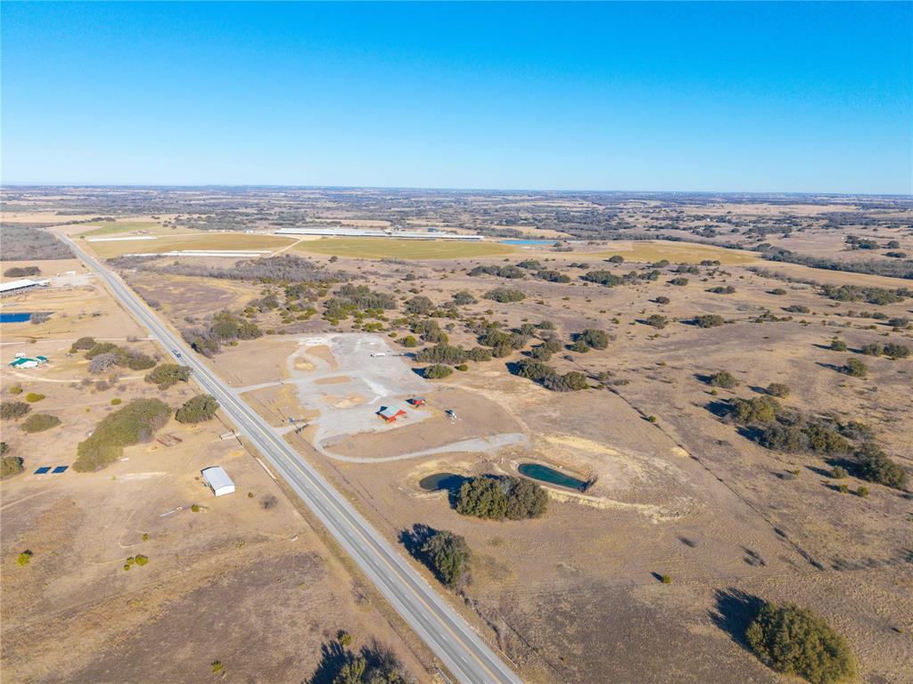 25.03 acres, property is fenced and has an all metal shop building, also a small elevated bunkhouse-office.  Water well and electricity are in place, 2 stock ponds, large, approx. 5 acre graveled area for truck parking or other uses.  Great location on State Highway 6 just 5 miles east of Dublin and near the Dublin Livestock Auction.