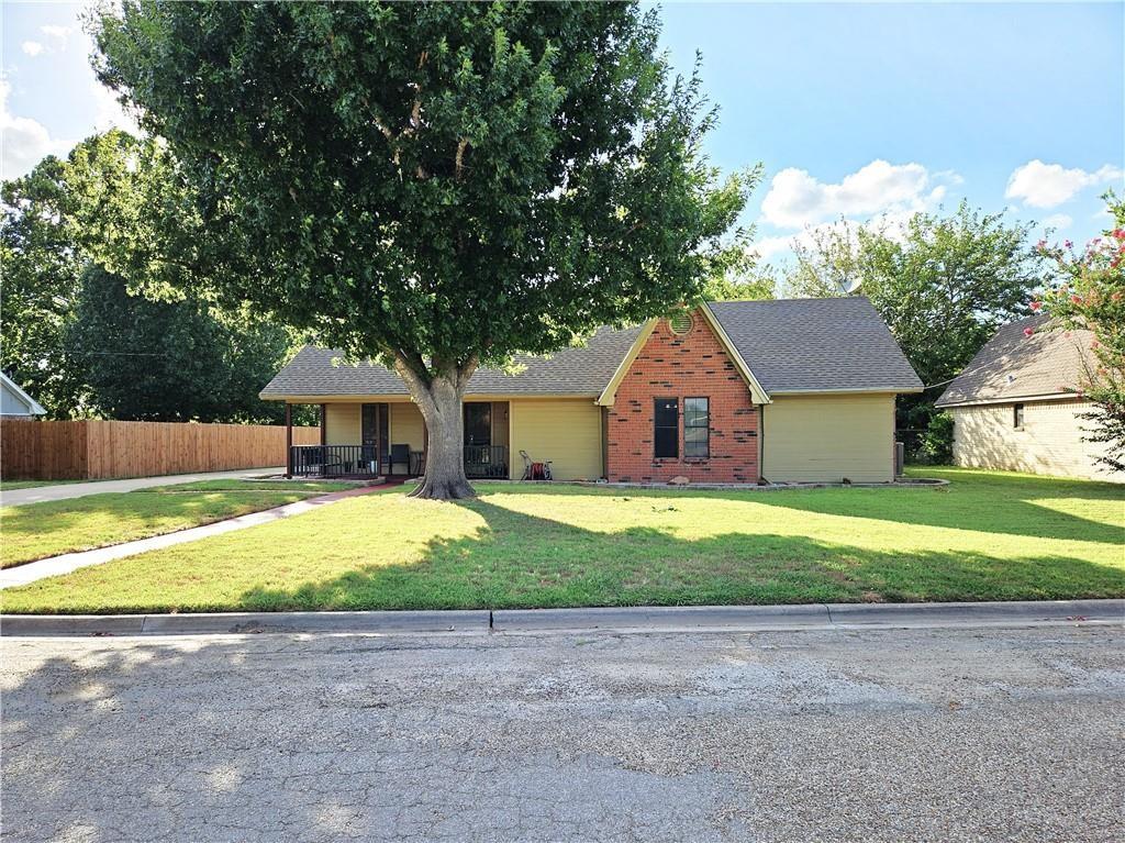 This beautiful 4-bedroom, 3-bathroom brick home sits in a fantastic neighborhood on the edge of Mexia and offers the perfect blend of comfort, space, and functionality. With 1,964 sq ft of well-maintained living space, the home features a mostly open floor plan, two master suites, and thoughtful updates throughout.

Step inside to find vaulted ceilings, a cozy wood-burning fireplace, updated neutral paint, and tile flooring throughout. The kitchen includes granite countertops, a large pantry, and excellent storage. The layout provides two spacious master bedrooms with attached bathrooms, plus two additional guest bedrooms and a full guest bath.
Outside, the property truly shines. A 1,200 sq ft workshop—complete with an office area, 20-amp electrical service, and an additional 30-amp RV plug—offers endless possibilities for hobbies, storage, or business use. Enjoy the outdoors on the covered front and rear porches, and relax in the privacy-fenced backyard shaded by mature trees.

This home is move-in ready and packed with features that are hard to find in one place.