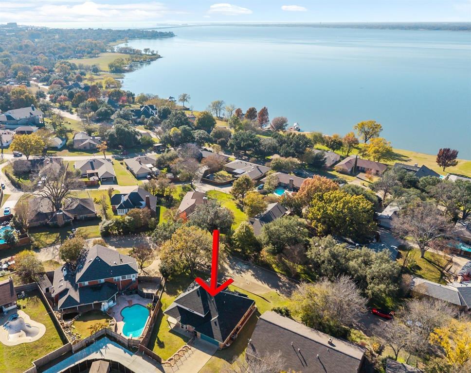 Located in one of Rockwall's most sought after lakeside established (TREES) communities tucked on a low traffic drive. Beautifully updated home READY NOW. Full of mature trees and Lake views & one block from Lake Ray Hubbard & is within Rockwall ISD!  Updates include fresh paint, lighting, windows, carpet and LVP floors. Just move in and enjoy! Minutes north from the Historic Downtown County Square with lots of shopping & fine dining and minutes south from the Harbor Entertainment District with lakeside dining, shopping and movies etc.  EZ access to I-30 East or West & just around the corner from HWY 66 for quicker access to George Bush Frwy into North Dallas and DFW Airport. Because of its superior lakeside location, properties in the area are beginning to be bought, scraped and rebuilt with much more expensive properties which is usually an indication of property values increasing.  Don't miss your shot!