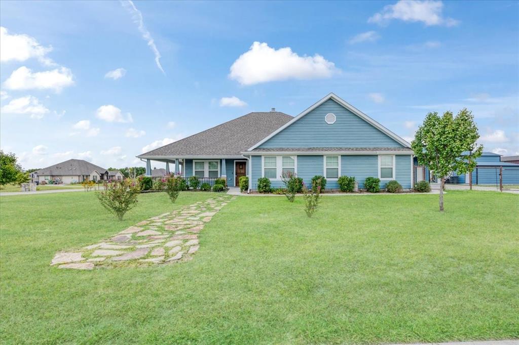 Welcome to Caddo Fork Estates with NO HOA and NO CITY TAXES!!  Discover the perfect blend of country charm and modern comfort in this exquisite 3-bedroom, 2-bath home with FRESH EXTERIOR PAINT, tucked away on a corner lot just outside the city limits of Caddo Mills, TX. A spacious 530 sq. ft. front porch sets the tone, inviting you to relax and take in the peaceful surroundings and lovely views of your pipe fenced back yard—The additional side and rear covered porches provides even more outdoor living space. Inside, the open floor plan boasts lovely solid wood floors, a 15x20 great room centered around a warm and cozy wood-burning fireplace The chef-inspired kitchen offers a stunning 8x5 granite island with electric, farmhouse sink, granite countertops, abundant cabinetry, a large pantry, and an electric range—open to the breakfast and living areas for seamless entertaining. The master bedroom is spacious and offers carpeted floors, ceiling fan, & a HUGE CUSTOM walk in closet and flows effortlessly into the spa-like master bath with skylight, Garden tub, separate tile shower and his and her vanities. The secondary bedrooms are roomy with ample closet space, lovely carpet and ceiling fans.  In addition, the property offers an electric gate for privacy and is nestled on 1.509 acres, with the backyard enclosed by pipe fencing and two gates.  For the hobbyist, craftsman, or extra storage needs, you’ll find NOT ONE, but TWO INSULATED WORKSHOPS: a 24x24 workshop with electric & a 10' RU door, 2 exterior doors & an extended 20X24 front covered carport with concrete parking; and ANOTHER 23x20 workshop with electric, a 10' roll-up door with a 20x11 rear overhang for outside parking or storage. This home checks every box for luxury, comfort, function, while country living makes it perfect for the kids and pets with plenty of room to romp!  Just minutes from town, yet offering the tranquility you deserve.  A MUST SEE!