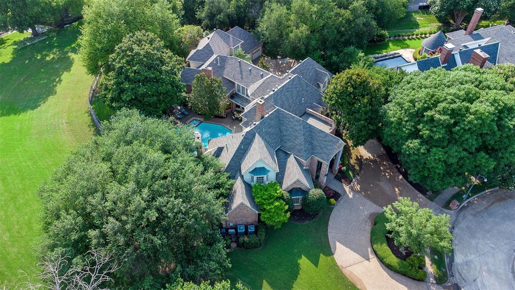 EAST facing estate backs to a lovely greenbelt and overlooks a beautiful creek. This fabulous home is nestled on a quiet cul-de-sac in Willow Bend Lakes.  As a multigenerational home, there is room for all ages and plenty of living spaces. The primary suite has an attached sitting area as well as an exercise room off the en-suite. An in-law suite is on the opposite side of the home next to a full bar which could easily be converted to a kitchenette. Upstairs are 3 bedrooms all with en-suites, a large playroom, additional office & media room. A diving pool, outdoor kitchen, gazebo, & plenty of grass space is perfect entertaining, play or pets. Views are stunning from the backyard. Circle drive and porte-cochere.