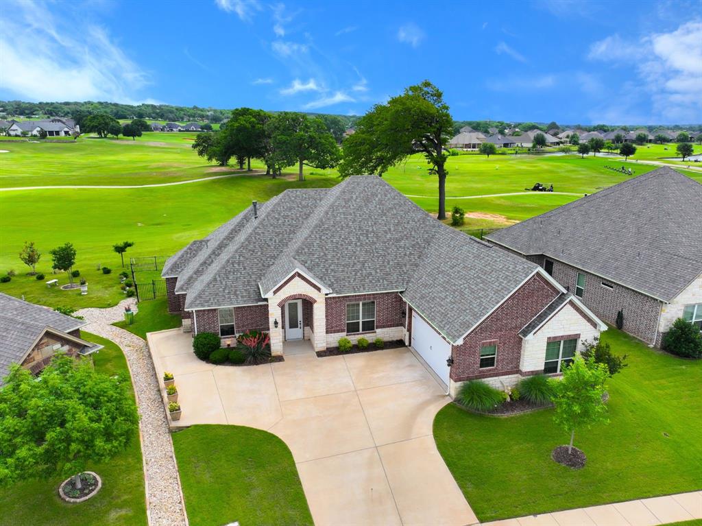 Situated along the golf course in Harbor Lakes, this very attractive and lovingly maintained home offers a comfortable and inviting open concept layout with thoughtful features throughout. The living room , dining room and kitchen all enjoy a wall of windows overlooking the Harbor Lakes Golf Course taking full advantage of the lush landscaping of this championship course. The open concept is also ideal for daily living and casual gatherings. The kitchen features granite counters, a gas cook-top, double ovens, walk in pantry, a large center island, and a separate breakfast bar. The split-bedroom floor plan provides a sense of privacy, with the primary suite located apart from the secondary bedrooms. The primary bedroom is generously sized and includes a well-appointed en-suite bath with double vanities, a seated vanity area, large luxurious walk in shower and the bench seat hides all of the plumbing should you decide you want to add a bathtub sometime in the future. Don't miss the oversized walk-in closet that connects directly to the laundry room. A dedicated office with double glass-pane doors and a closet provides a flexible space for working from home, a home library or even a guest room for overflow guests. The large covered back porch is fully screened and offers a relaxing spot to enjoy the view in a comfortable, insect free setting.  Walk to the Harbor Lakes Country for fine dining and social activities or jump in the golf cart for a quick 18 holes. A new roof was installed in 2025, and the property includes a 2-car garage along with a dedicated golf cart garage.   (membership to Harbor Lakes is optional, not included in HOA) .