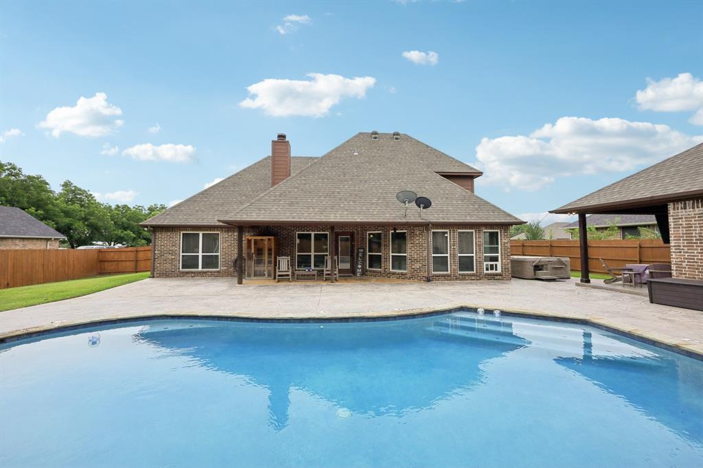 Location & Tranquility! Luxury meets country in this immaculately maintained, custom-built home at the end of a cul-de-sac in the established Meadow Park Addition. Enjoy in-town convenience with a quiet, tucked-away feel — minutes to groceries, local sports, and just minutes to local schools. Step inside to a wall of windows flooding the space with natural light and showcasing a backyard retreat designed for both seclusion and entertaining. The kitchen offers ample counter and prep space to keep gatherings flowing inside & out. Imagine coming home in that mid-July summer bake-a-thon & slipping into the refreshing waves of your own chill oasis.  Hosting guests? A separate guest house offers a bedroom, bath, closet & even a separate covered patio for added privacy. The main home’s first-floor owner’s suite boasts a soaker tub, shower, dual vanities and a jaw-dropping walk-in closet. Upstairs, you’ll find two bedrooms, an ample-sized full bath, and a media room above the garage—perfectly located for movie nights or gaming without disturbing the rest of the house. What?  There's more? NO HOA, NO MUD, NO PID. Ideal for multi-generational living with the perfect balance of connection and independence. Whether you love to entertain or prefer peace and quiet, this home delivers. You will swear you are country!  Birds chirping, wind blowing and roosters crowing--all can be enjoyed while sipping your morning coffee or a tall glass of ice tea on your back patio!  Don't hesitate---Call right now to reserve your private showing!  ***Before Mother Nature turns up the heat to broil!***