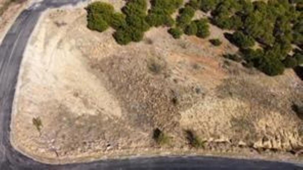 Build your dream home or weekend escape on this exceptional one-acre homesite nestled at the top of a hill in the desirable Hills Above Possum Kingdom Lake. Tucked within a gated northern Hill Country community, this property offers a peaceful, private setting highlighted by breathtaking views of Possum Kingdom Lake and sweeping countryside vistas. The lot features natural rock formations, elevation changes, and native trees that add character and privacy, while still offering a desirable, relatively level area that provides an ideal building site for a thoughtfully designed custom home perfectly positioned to capture stunning lake views, dramatic sunsets, and the beauty of the surrounding Hill Country landscape.

Water and electricity are available at the street, making the property ready for your future plans. There is no requirement to build immediately, allowing you to move at your own pace and select the builder that best fits your vision. CCRs require a minimum 2,500 square foot residence. When the time comes, the seller does have thoughtfully designed home plans available that may be customized if desired.

Lot ownership includes access to all neighborhood amenities, including boat storage, a community boat ramp and dock, clubhouse with pool and fitness center, fishing pond, lake access, picnic area with cabin, nature trails, and more than 20 miles of private gated roads—offering the perfect balance of lake recreation and quiet country living. Enjoy the freedom of acreage living with resort-style amenities, breathtaking scenery, and the relaxed Possum Kingdom Lake lifestyle, all less than two hours from the DFW Metroplex. Contact the listing agent to discuss build-to-suit options or available builder opportunities.