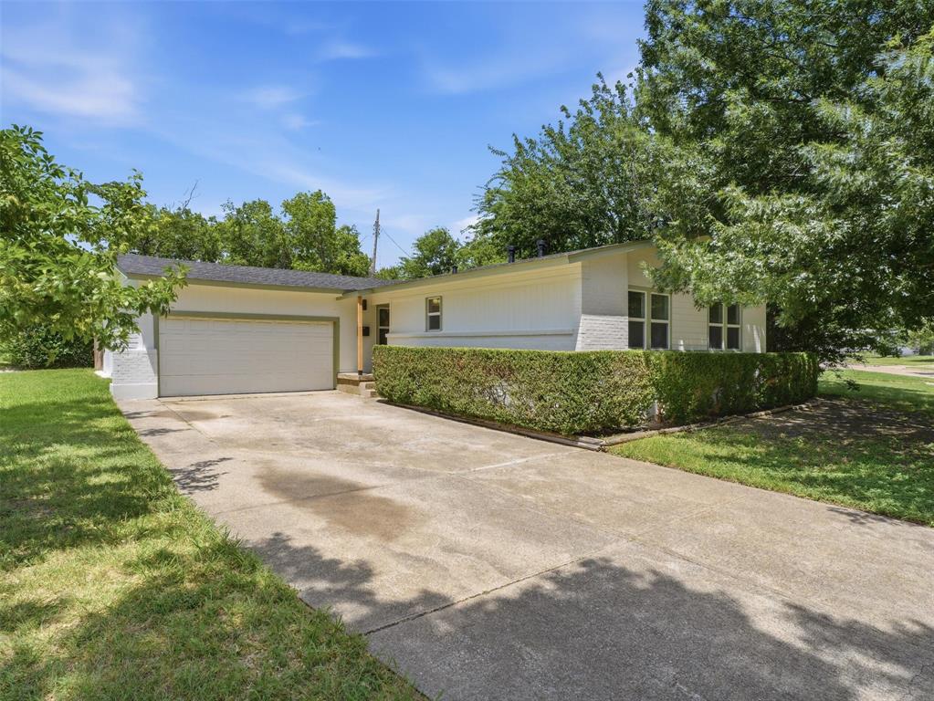 Welcome home to this beautifully renovated property on an oversized corner lot, where modern updates meet timeless charm. Inside you'll find refinished original hardwood floors, custom cabinets, quartz countertops, LG appliances, oversized tubs, and walk-in closets. Major updates include a new roof, new HVAC system with all new ductwork, and fresh interior and exterior paint. The home also features an electric fireplace with a hidden TV mount, a privacy-fenced backyard with a French drain, and a 200  sq. ft. extra room not included in the square footage with a dedicated laundry sink, custom cabinets, and ample counter space; could be a great home gym or shop.