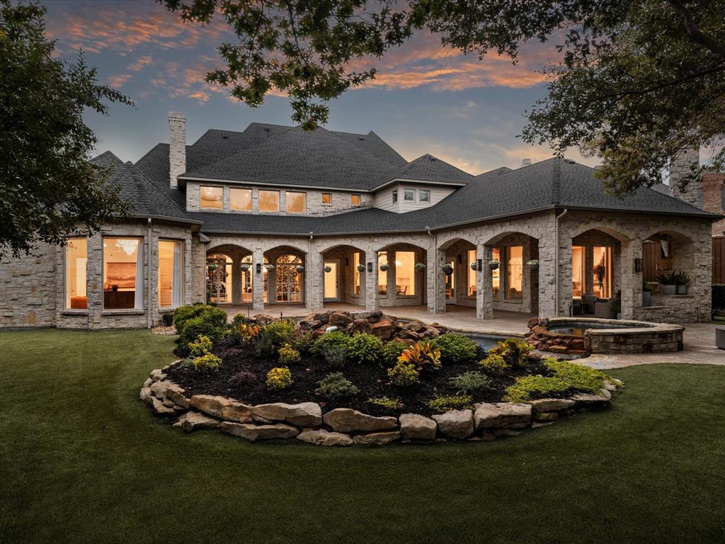 Luxurious Lonnie Gray custom home with a 2025 floor to ceiling renovation blends Old World charm & modern luxury. An elevated lot with mature trees offers dramatic curb appeal & privacy. 22-ft ceilings create European grandeur with exquisite millwork, moulding, & masonry. Natural light pours through custom French doors & windows. Highlights include 4 fireplaces, 2 staircases, downstairs media room, 2 powder baths, & wet bar. The kitchen features a 60”paneled fridge, warming drawer, dual dishwashers, & custom cabinets. The Primary suite boasts a fireplace, sitting room, & oversized bath & closet. Outside is an oasis with pool, waterfalls & spa, kitchen, large covered patio, fire pit, & turfed lawn beneath a lush canopy. Other amenities: wide-plank oak floors, designer lighting, full stone exterior, security cameras, sound system, Tesla charger, upstairs gym, & game room. The personal home of a designer & builder, this home embodies taste & quality craftsmanship that is one of a kind.