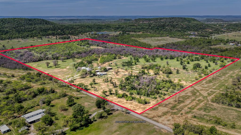 just 30 mins west of Weatherford Its the country life not too far out but far enough.
 63 Plus acres with a pond, creek, and tons of wildlife located on a dead end road that eliminates traffic. 
 Would make a great ranch or  hunting propery. The property has two homes one Modular that has a garage with a cement slab floor and a double wide mobile home both very well maintained and move in ready. The property has a covered RV sight with Electricity, a shop and a barn.  
 This property is fenced and cross fenced for calf pens. It's bordered by rolling hills to the back and large ranch properties border the sides.
 During my first tour of the property we saw several deer, Turkey, and one coyote. 
This is a must see place if you are looking for a place to get away or a place to raise a family. The area schools are awesome. The local restaurants are absolutely the best from country cafe style, to a sit down steak house, throw in a food truck or two and you won't be disappointed. 
Gordon has a lot to offer Hardware store, shopping ate the mercantile, hairdresser and barber its small town charm is addictive.