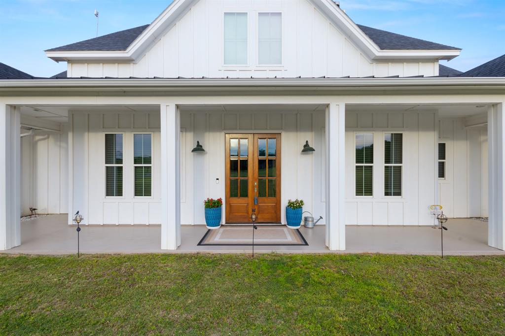 Summertime in Decatur, Texas doesn't get much better than this: over 5 acres of unrestricted land, with NO CITY TAXES, but still just minutes from all the convenience that Decatur has to offer. A private well, septic system and a new water filtration system are added bonuses to this property. The oversized 3 car garage is perfect for projects or hobbies, with room to spare for all your vehicles. 
Inside, you will find beautiful wooden ceramic tile floors throughout and natural sunlight floods each room of this immaculately kept home. With an open concept kitchen, dining and living area, family time and entertaining are a breeze. The gourmet kitchen features custom cabinetry, quartz countertops and all KitchenAid appliances. A very generously sized pantry and half bath are just off the kitchen for convenience.
The large primary bedroom, with vaulted ceilings, is on one side of the home and the remaining 3 bedrooms are on the opposite wing, with 2 sharing a Jack & Jill bath. The homeowner has customized each bath with exquisite tile work that you must see to appreciate.
One feature you must experience is the back porch! With motorized screens and an AMAZING custom rock fireplace, it truly is the one place you will want to hurry home to enjoy. The screened in back porch will be your favorite morning coffee spot, your peaceful reading nook, or your new best place for entertaining dinner guests. It overlooks the serene back yard which is bordered by numerous mature trees. 
If you've been looking for space to spread out and the benefits of a newer home that's been well kept, you may just want to schedule your showing today, because this one won't last long!