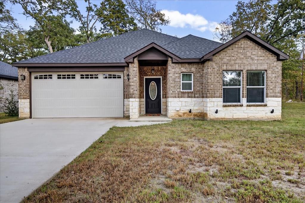 Experience modern lakeside living in this immaculate 2023 home in the gated Beachwood Estates community. This 3-bedroom, 2-bath residence showcases hardwood floors, a chef-inspired kitchen with a large quartz island and custom cabinetry, and an inviting open floor plan. The spacious primary suite includes a beautifully designed bath and an oversized walk-in closet. An additional lot provides extra privacy or future potential. Enjoy resort-style amenities including a community clubhouse, playground, boat launch, fishing pier, and pickleball courts—all within walking distance. Stylish, fresh, and move-in ready! The adjoining Lot 130 will convey with this property.  Seller pays separate dues of $276 for Lot 130.