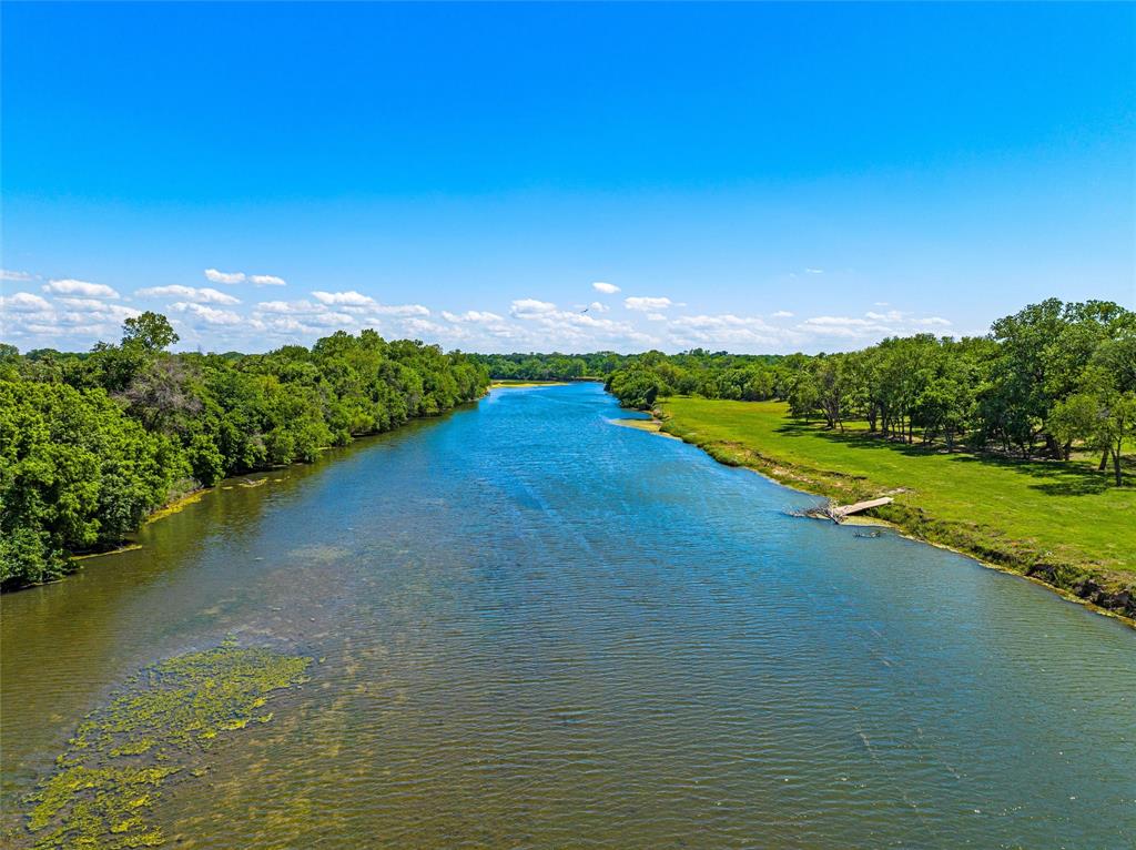 Brazos River Frontage and Direct Access - Lot 4: Keys on the Brazos - 58.84 acs of stunning and rolling riverfront land with beautiful views and direct access to the Brazos River. Rare opportunity to own a premier residential farm & ranch lot that offers both the tranquility of country living and the convenience of being a minutes from the city. Outside the city limits but with city utilities, this one of a kind, restricted development offers a lifestyle with an abundance of woods, peaceful pastures, creeks to explore, springs and the Brazos River. Over 800 ft of river frontage that is approved for docks makes this unique property perfect for fishing, kayaking, boating, SAIL-GATING to Baylor football and basketball games or simply enjoying the serene water views. Build your dream home, run cattle, raise horses, enjoy the kids and grandkids playing! Keys on the Brazos is the perfect place for families, recreation, relaxation and making memories. Nature abounds, bluebonnets bloom, deer graze, birds chirp and the creeks and river flow. City of Waco water and sewer. Oncor electric, Restricted homesites not affiliated with Keys Creek or Keys Creek HOA. Bosqueville ISD. Ag Exempt. All maps are approximate. Survey will be provided. Direct river access to Foster Pavilion (basketball stadium), McLane football stadium, Downtown and Baylor University. Minutes from Waco, China Spring, Bosqueville and I-35. Enter property off Grove Creek Dr. culdesac. Lots are platted and Seller will provide the survey.