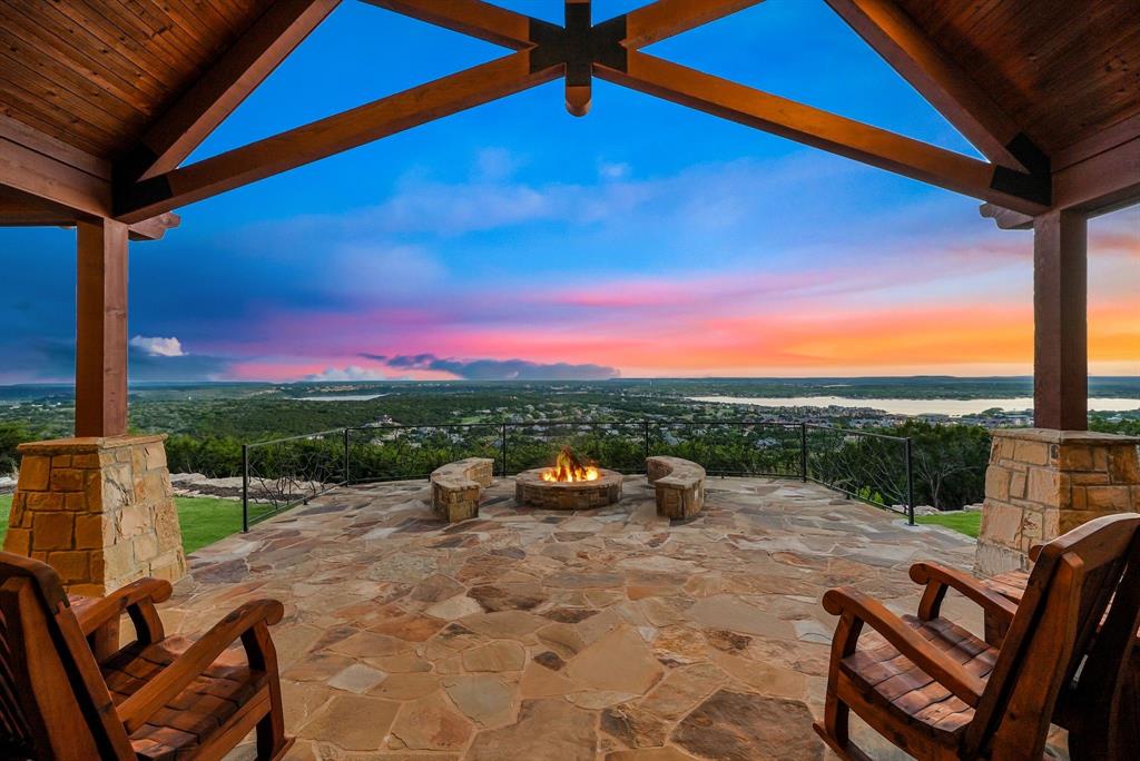 Experience the pinnacle of luxury at 1230 Plateau Place, an inspiring sanctuary perched atop the highest reaches of Possum Kingdom Lake with grand views of majestic Palo Pinto mountain peaks and sprawling blue waters. This masterfully curated estate has undergone a recent total remodel where no expense was spared, resulting in a top-notch custom home that radiates sophistication. The heart of the property is an amazing backyard outdoor living space designed to capture infinite vistas, featuring a new pool and jacuzzi, vibrant color lighting, and a state-of-the-art sound system—all effortlessly controlled via remote technology. As the sun sets, ceramic gas logs in the firepit accent the twinkling lights of the valley below and the brilliant Texas stars. Inside, the floor plan is perfection, offering a grand living room for entertaining, a relaxed second living area, and all-luxury bedroom suites that enjoy lush, professional landscape views. A private upstairs guest apartment ensures comfort for visitors, Living in the prestigious Ranch development provides access to unparalleled amenities, including a world-class equestrian center, a million-dollar community pool, a comprehensive sports complex, and 1,100 common acres of diverse topography to roam as your own. Complete with a boat slip available for transfer, this perfectly maintained estate offers the definitive lake lifestyle for the most discerning buyer.  The adjacent lot can be purchased as well for added privacy.