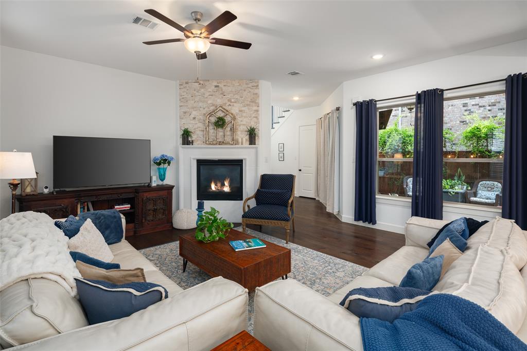 Luxury abounds in this stunning Craftsman-style home with serene views of a tree-lined greenbelt! The gourmet kitchen features a granite island, custom wood-stained range hood, stone backsplash, brushed gold fixtures, and upgraded lighting. A beautiful stone fireplace highlights the living room, which opens to an exceptional outdoor space with a covered patio, decorative lighting, freshly painted deck, and low-maintenance turf—ideal for relaxing or entertaining.The spacious primary suite offers an en suite bath with natural light, upgraded tile, a large walk-in shower, and seasonal racks in the generous closet. Upstairs, enjoy a versatile loft, dedicated media room, and additional bedroom with plantation shutters and a cozy reading nook. The downstairs guest suite—with en suite bath and shutters—can easily serve as a second primary. Additional highlights include recently installed carpet, custom mudroom cabinetry, and an oversized 2.5-car garage. Energy-efficient features include a tankless water heater, Low-E windows, 16 SEER HVAC, and smart home capabilities. Located near Lovejoy schools (possible by an application process), major highways, shopping, and dining—this home has it all!
