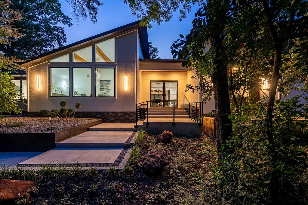 This exquisite residence is nestled among the trees on one of Kessler Park's most iconic streets, just moments from the vibrant heart of Dallas & is a perfect blend of sophistication, modern style, and luxury, situated on a lush, heavily wooded lot. The open floor plan seamlessly connects multiple living areas, ideal for gatherings. Elegant formal dining offers spectacular views. The expansive kitchen, with a prep kitchen and a large island adorned with a unique, nature-inspired countertop, is a culinary masterpiece. 
Step outside to your private oasis, featuring a heated pool, jacuzzi, outdoor kitchen, fire pit, & ample grassy space to enjoy this hilltop haven. The owner's suite is a sanctuary, boasting a spacious bedroom that leads to a magnificent bathroom with double vanities, a frameless glass twin shower, an elegant stand-alone tub, and a generous walk-in closet. This home is your unique sanctuary, harmonizing luxury and nature in one extraordinary setting.