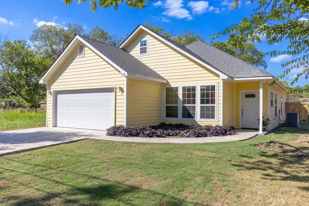 This charming 1588 sq ft home features a sunny yellow exterior with crisp white trim, giving it a welcoming and cheerful appearance. This 3- bedroom 2-bathroom with an office featuring a wall of large windows. The front yard is well-maintained, with manicured landscaping. The kitchen is a standout feature with sleek white cabinets, quartz countertops, stainless steel appliances, and ample counter space, making it a stylish and functional space for cooking and an eat-at bar for entertaining. The wood-like tile flooring throughout the living areas provides a warm touch while being easy to maintain. The backyard is the highlight of this property, featuring a large, treed lot and private space enclosed by a privacy fence. The property includes a convenient 2-car garage, providing secure parking and storage space. Located in Commerce, Texas, which is known for its small-town charm and proximity to amenities like shops, schools, and parks. Come take a look!
