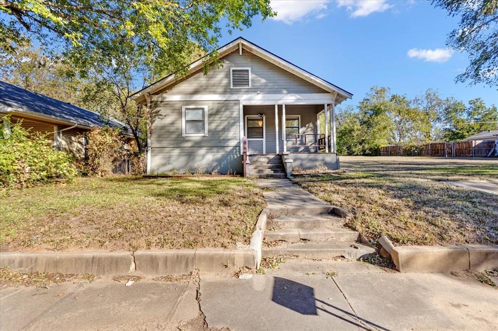 Welcome to this well-maintained, charming home in the heart of Denison! This lovely 2-bedroom, 1-bathroom property offers comfortable living spaces and a fantastic outdoor area.  Step inside to discover the warmth and character of original wood flooring that flows throughout the main living and dining areas.  Flexibility in functionality and decorating with open areas, and the home features some new paint, offering a bright and move-in ready feel. A flexible bonus room provides extra space that can easily function as a nursery, a spacious walk-in closet, a home office, or a quiet reading nook – customize it to fit your needs! Enjoy the convenience of a large utility room with ample space for laundry and storage. The property boasts a fully fenced backyard, perfect for outdoor entertaining, gardening, or children and pets to play. Relax on the inviting covered porch or utilize the practical alley access for convenience. This home is a true gem, combining classic charm with functional living spaces. Don't miss the opportunity to make it yours!  This parcel may be purchased with the additional lot (MLS # 21114735) or singularly with house and lot, (MLS 21115917).