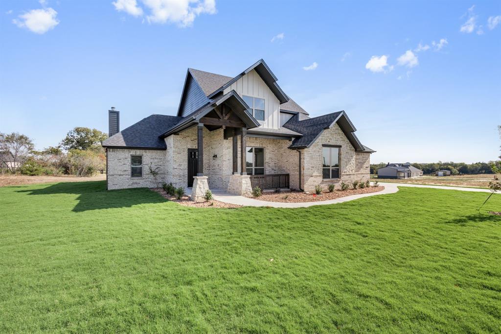 EVERYTHING IS BIGGER IN TEXAS... AND THIS HOME PROVES IT. The only thing that's not oversized is the price tag. Situated on a private 1-ACRE lot with a beautiful tree-lined backdrop, this brand-new home delivers the space, quality, and flexibility buyers are searching for—at a price that's HARD TO BEAT. The versatile floorplan offers the option of 4 bedrooms plus an office, or 3 bedrooms with a gameroom and office. Every room is generously sized with WALK-IN CLOSETS, giving everyone plenty of room to spread out. At the center of the home is an ENORMOUS kitchen built for entertaining, featuring a massive island, custom soft-close knotty alder cabinetry, and storage for days. The spacious living room showcases a floor-to-ceiling stacked stone wood-burning fireplace with a custom cedar mantle, creating the perfect gathering space. Additional upgrades include wood-look tile throughout the main living areas, entry, and office, upgraded matte black fixtures, ceiling fans in every room, quartz countertops in all bathrooms, and custom cabinetry throughout. Bring the TEXAS SIZED TRUCK! The OVERSIZED 24x30 THREE-CAR GARAGE features 8-foot doors designed to accommodate larger vehicles with ease, plus Hardie board baseboards for added durability. Enjoy peaceful country living from the covered front and back porches while benefiting from NO CITY TAXES and a LOW 1.5% tax rate. Located in highly sought-after MAYPEARL ISD and less than 10 minutes from shopping, dining, and everyday conveniences, with quick access to both I-35E and I-35W for an easy commute anywhere in the Metroplex. Estimated completion is September, giving buyers the rare opportunity to secure the home now and select many of their own colors and finishes. Photos are of the builder's completed homes in the neighborhood and are intended to represent quality, craftsmanship, and design. ROOMS ARE SO MUCH BIGGER IN PERSON, THIS IS A MUST SEE! Ask agent about additional homes available.