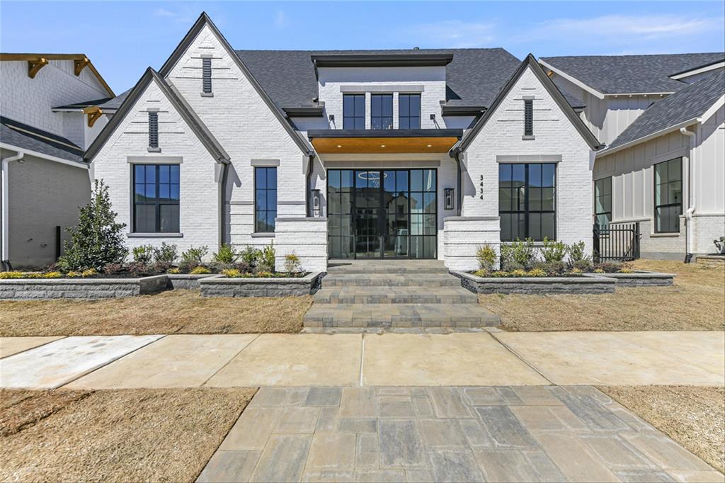 MLS# 20798159 - Built by Huntington Homes - Ready Now! ~ Award-winning Marcello plan by Huntington Homes. Painted white brick with 10ft tall glass double door entrance welcomes you into this showstopper! 22ft high beamed ceilings in great room w huge windows & 10ft tall sliders overlooking outdoor living. Luxury abounds in this home w Wolf & Subzero appliances, Quartzite countertops, Prep Kitchen w 2nd fridge, 2nd dishwasher, icemaker, oven & microwave allows you to have a clean kitchen for entertaining. Downstairs media room is perfect for watching the big game. Glass enclosed study w pocket office overlooks backyard. Custom closet in Primary along w floating vanities, freestanding tub & massive shower w multiple shower heads. All en-suite bedrooms for privacy. Gameroom has wet bar w sink, microwave & beverage fridge. Outdoor living has Wolf grill, venthood, sink, beverage fridge and fireplace to enjoy all seasons of the year. Upgrades galore. Hurry, this one wont last!!!