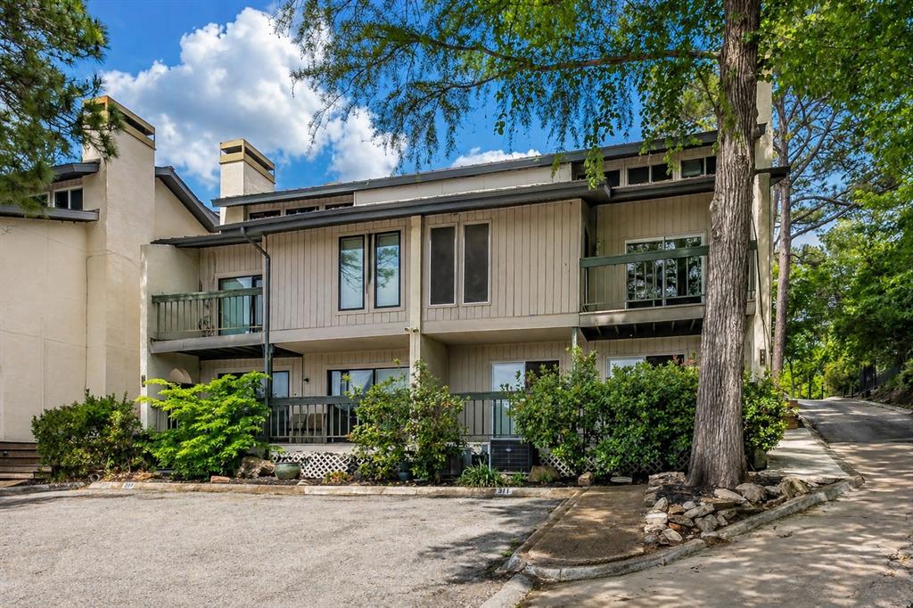 Welcome to lake living at its best on a quiet, secluded peninsula of Eagle Mountain Lake. This beautifully updated condo offers lake views from the second and third floors, abundant natural light, and the perfect blend of relaxation and convenience. Located next door to the prestigious Fort Worth Boat Club, this property offers a rare opportunity to enjoy one of Eagle Mountain Lake’s most sought-after waterfront locations. Enjoy the convenience of being just steps away from boating, dining, social events, and lakefront activities. The main living area features soaring vaulted ceilings, a cozy wood-burning fireplace, Luxury Vinyl Plank flooring, and a private balcony ideal for enjoying peaceful mornings or evening sunsets. The kitchen is designed for both functionality and entertaining, complete with a nearby laundry area, additional storage space, and a convenient half bath for guests. Downstairs, both bedrooms offer private en suite bathrooms, creating an ideal layout for guests, roommates, or full-time living. The spacious primary suite includes lake views, and a full bath.  Just a short walk away, enjoy easy access to the waterfront, community boat dock, fishing dock, swimming area, and beautifully maintained picnic spaces. Insurance - $211.13, Utility $159.24 and Cable $52 are billed through HOA.  Whether you are looking for a full-time residence, weekend escape, lock-and-leave lifestyle, or investment opportunity, this condo delivers affordable lake living in one of Eagle Mountain Lake’s most desirable locations.