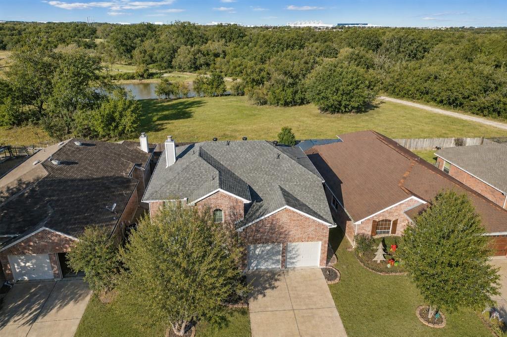 Backing to a greenbelt and pond, this updated home offers exceptional privacy with no rear neighbors and is located within Northwest ISD, feeding to the highly acclaimed Byron Nelson High School and within walking distance of both elementary & middle school. Conveniently located off I-170 with quick access to  I-35W & Hwy 114, this location offers easy access to Alliance,Southlake, Grapevine, Downtown Fort Worth, you'll also be just minutes from Tanger Outlets and historic Roanoke, officially known as the Unique Dining Capital of Texas. Inside, the open-concept floorplan features wood-look tile flooring throughout the first floor, all new fresh new paint (2026), updated lighting (2026), and all-new carpet (2026). Fully renovated kitchen showcases dual granite islands, stainless steel Bosch Dishwasher & SS appliances, including a double electric range oven, a single-basin sink, and abundant white shaker cabinetry. Upstairs primary suite features wood flooring with a custom-built office with extensive cabinetry & shelving. The converted primary bath offers a unique expansion featuring an oversized walk-in shower and a unique custom closet within the finished attic. Upstairs also offers a game room with vaulted ceiling, two secondary bedrooms, and an updated bath with granite countertops and upgraded vanity. Backyard features an extended patio and peaceful views of the heavily treed greenbelt beyond. A storage shed conveys with the property, while nearby parks and trails complete the outdoor lifestyle. Roof replaced in 2021.