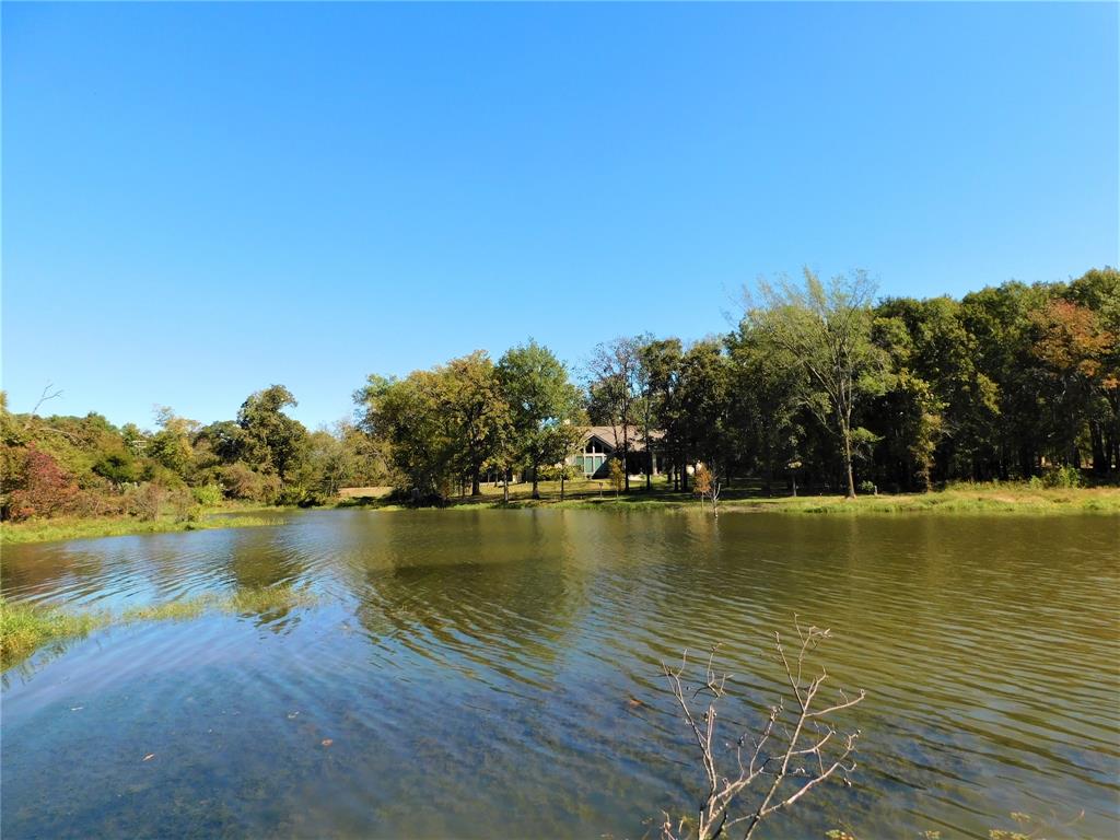 Embrace serene waterfront living at The Shores on Richland Chambers Lake with this exquisite pond-front lot on a quiet cul-de-sac. Spanning just over half an acre, this prime parcel offers an idyllic setting for your dream home. With 113 feet of water frontage, just walk straight out your door to cast a line into the private stocked pond reserved only for The Shores residents. This subdivision is limited to site built home of a minimum of 1,800 square feet, so you can rest assured your home will always be surrounded by the best. Nestled within a gated community, enjoy exclusive access to unparalleled amenities, including a clubhouse boasting a resort-style pool and a state-of-the-art fitness center. For avid boaters, delight in the convenience of a private marina and boat ramp, experience  adventures on the tranquil waters of Richland Chambers Lake. Craft your vision of the perfect lakeside retreat amidst breathtaking surroundings, where luxury meets natural beauty.