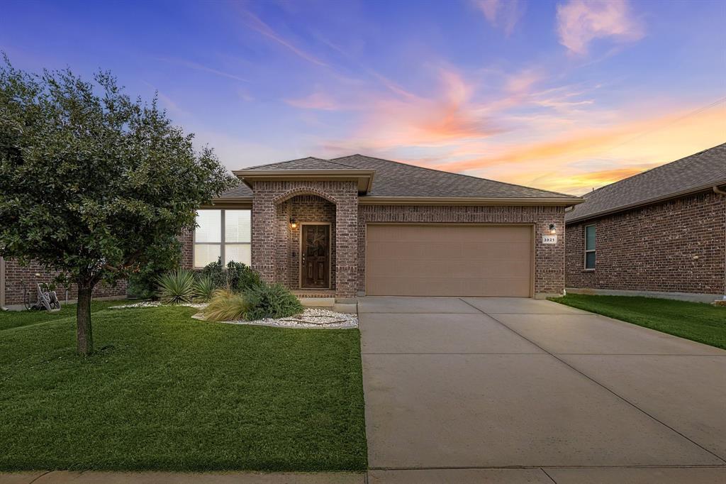 Move-In Ready Comfort! Enjoy easy living in this charming single-story home zoned for top-tier Northwest ISD schools, feeding into Byron Nelson High. Offering a flexible open floor plan, the layout features a light-filled study complete with classic French doors, perfect for a private home office. Durable, new wood luxury vinyl plank flooring (2024) flows seamlessly through the main living spaces. The bright kitchen boasts freshly painted white cabinets accented by brushed nickel hardware, a spacious walk-in pantry, and ample counter space. Thoughtful custom touches include a large utility room with extra shelving and a clever built-in wall dog crate. Outside, a professional French drain (2025) and stepping-stone gravel garden offer a tidy, low-maintenance yard. Step out onto neighborhood greenbelt trails connecting to a community pool, park, playground, and fishing ponds. Best of all, enjoy walking distance to the local middle school with easy evening access to the track, tennis, and pickleball courts. Schedule your tour today!