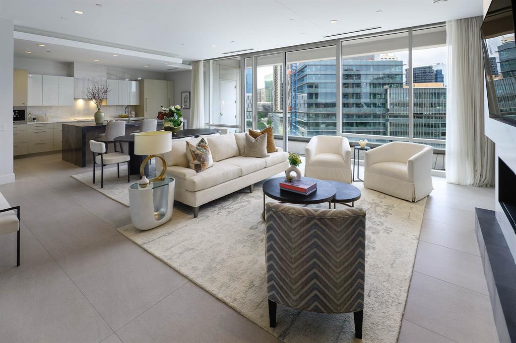 Sophisticated high-rise living in the heart of Victory Park, just steps from the new Goldman Sachs campus—quickly becoming known as “Y’all Street.” Thoughtfully renovated from top to bottom, this refined residence blends elevated finishes, sleek design, and a seamless open-concept layout with expansive walls of glass, a generous covered terrace, and striking skyline views.

The spacious living and dining areas are anchored by a sleek fireplace and finished with large-format stone flooring, custom electric shades and drapes, and designer details throughout. Seamless indoor-outdoor flow creates an ideal setting for both everyday living and entertaining.

The chef’s kitchen is beautifully appointed with exquisite stone countertops, a Sub-Zero refrigerator, full-size wine chiller, built-in Miele coffee maker, and premium appliances designed for effortless functionality and style.

The spacious primary suite is a private retreat, featuring a spa-inspired bath with a freestanding soaking tub, luxurious stone finishes, and a custom closet finish-out. A versatile bonus space offers the perfect setting for a home office, library, or private lounge. A generous guest suite with en suite bath completes the condo.

Residents enjoy access to world-class amenities including 24-hour concierge, resort-style pool, fitness center, valet, and exclusive Marriott hotel services synonymous with W living. Just steps from premier dining, entertainment, American Airlines Center and the Katy Trail, this is lock-and-leave luxury at its finest in one of Dallas’ most dynamic business and lifestyle destinations.