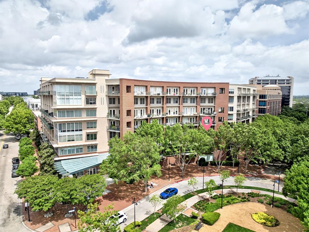 Discover Urban Elegance in the Heart of Addison with this exquisite 2-bedroom, 2-bathroom residence. This beautifully appointed home offers a seamless combination of modern luxury and timeless style with an abundance of natural light and premium finishes throughout.  Upon entering, you are greeted by rich oak hand-scraped floors that extend through the living spaces, accompanied by a stunning custom-designed banister. The living area is adorned with majestic wood ceiling beams, lending a sense of rustic elegance. Floor-to-ceiling windows not only flood the interior with natural light but also provide unobstructed views of the serene surroundings.  The gourmet kitchen is a chef's dream, featuring soft sage cabinetry with distressed finishes and complemented by exotic granite countertops. An inviting island and classic farmhouse sink provide both functionality and charm. State-of-the-art commercial appliances, including a stainless steel Viking range and Thermador dishwasher, ensure culinary endeavors are met with ease.  Both Bedrooms offer tranquil retreats, enhanced by expansive windows that welcome morning light. Retreat to the primary suite where comfort meets luxury in the well-appointed bathroom with designer finishes.  Step outside to find two private balconies, perfect for unwinding while enjoying picturesque views of the community pool and the lush landscape of Beckert Park. The location offers an array of amenities beyond the home, with Addison Circle Park just a short stroll away, hosting vibrant festivals throughout the year. Indulge in an array of dining establishments and boutique shops, all within walking distance, ensuring that the best of Addison is always at your doorstep.  With 2 assigned parking spots convenience is matched by the vibrant lifestyle this residence affords, making it a truly exceptional offering in one of Addison's most sought-after locations. HOA includes Water, Gas, Pest Control, Internet, Cable, Concierge Services, trash and more.