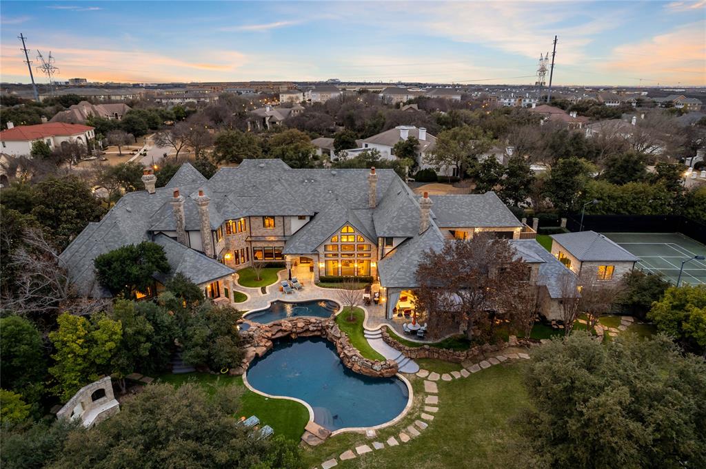 6413 Old Gate Road
A timeless masterpiece in the ultra-private Kings Gate subdivision in North Plano, this estate sits on nearly two acres of lush grounds that were once part of the legendary Willow Bend Polo fields.
The limestone façade, slate roof, and enduring pier-and-beam construction set the tone for timeless elegance. Soaring two-story ceilings and museum-quality windows frame an interior finished with oak, limestone, and marble floors.The gourmet kitchen, adorned with artisanal cabinetry, is an entertainer’s dream and includes a spacious secondary catering kitchen that flows seamlessly into the grand living spaces. The entire residence is automated with a state-of-the-art Control4 smart home system.
This versatile floor plan features 7 en-suite bedrooms, 11 bathrooms and an 6 car garage.The first-floor owner’s sanctuary is a private retreat complete with his-and-hers bathrooms and wardrobes, a sauna, and an intimate staircase leading to a private wellness gym. Luxury amenities: a first-floor executive office with a mahogany coffered ceiling and fireplace, a 2,200-bottle climate-controlled wine cellar, a billiards salon with mahogany paneling and an executive bar, and dual media rooms—including a soundproofed theater .
The resort-inspired grounds redefine outdoor living with twin infinity pools, a gourmet outdoor kitchen,a full-regulation tennis court,& a newly constructed private tennis and pickleball clubhouse perfect for lounging and entertaining.All are nestled within lush gardens,with numerous patios and seating areas offering unparalleled privacy for intimate gatherings or grand-scale events.
Perfectly positioned in one of Plano’s most coveted neighborhoods, the home is just minutes from world-class golf courses, Grandscape, Legacy West, and The Star.It also offers easy access to DFW Airport, Love Field, Addison Private Airport, close to Trinity Christian, Legacy Academy, and Prince of Peace School. FULL property video tour available upon request