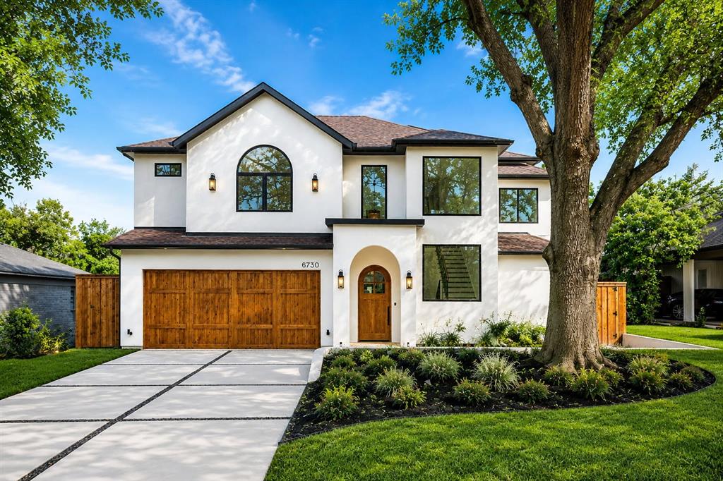 Sleek stucco, warm oak, and sculpted arches signal what’s inside at 8730 Rexford: a California Spanish Modern that mixes romance with restraint on a quiet Bluffview lane. Conceived by MJR Development and executed by Barcus Homes, the residence opens to a dramatic foyer with checkerboard stone flooring and arched passages that lead to a luminous great room. Twelve-foot ceilings, white-oak beams, and a cast-stone fireplace set an elevated, effortless mood while sliders connect to the covered loggia. The magazine-ready kitchen pairs custom white-oak cabinetry with Bellagio quartzite, a fluted island trimmed in brass, a Bertazzoni 6-burner range, and a true pantry or prep kitchen. Entertaining is seamless with a moody wet bar and an elegant dining area; outside, the marble-clad patio and fenced lawn extend the party. The first-floor primary suite lives like a boutique hotel—cathedral ceiling, custom closet with island, and a spa bath wrapped in Italian marble with herringbone limestone, freestanding tub, and glass shower. Four additional ensuite bedrooms join a private office, game room, and media room; throughout, wide-plank floors, bespoke hardware, and designer lighting underscore the craftsmanship. Two-car garage, modern drive, and easy access to Inwood Village, Lovers Lane dining, the Dallas North Tollway, Love Field, parks, and top private schools. Fresh, refined, and move-in ready—this is the Bluffview standout. Thoughtful extras include a striking arched front door, iron-and-oak stair, designer powder bath, generous secondary suites with walk-in closets, and a climate-controlled two-car garage with storage. Enjoy morning coffee on the covered patio beneath the tongue-and-groove ceiling and oversized fan. Walk or bike to Inwood Village cafés, Trader Joe’s, fitness studios, and neighborhood parks; it’s an easy 10 minutes to Love Field and the Tollway.