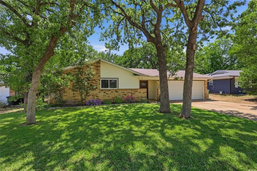 Nestled beneath mature shade trees in an established Bedford neighborhood, this beautifully updated home combines modern improvements with timeless charm. Situated on a generous .20-acre lot, the property offers an oversized backyard with plenty of room to entertain, garden, play, or  enjoy the privacy under the shade of surrounding trees. A welcoming covered front porch and thoughtfully landscaped beds filled with low-maintenance plants create inviting curb appeal from the moment you arrive.
Inside, the functional split-bedroom floorplan offers 3 bedrooms, 2 full baths, and a spacious layout designed for comfort. Luxury vinyl plank flooring flows throughout living areas and bedrooms - NO CARPET! Abundant natural light creates a bright and welcoming atmosphere. The spacious living room overlooks the backyard and opens to the breakfast room.  The updated kitchen features granite countertops, stainless steel appliances, a gas range, and plenty of cabinets. The private primary suite offers a walk-in closet and beautifully renovated en suite bath, while two secondary bedrooms share an equally updated full bath. Major updates provide peace of mind and true move-in-ready convenience, including system updates, new windows, and completed foundation work with a transferable warranty. Renovated bathrooms, updated finishes, and well-maintained systems allow buyers to enjoy the home from day one.
Step outside to the oversized back patio, which overlooks the expansive backyard shaded by mature trees, creating the perfect setting for outdoor dining, weekend gatherings, or relaxing evenings at home. No HOA! Conveniently located near shopping, dining, parks, and green space, with easy access to Hwy 121 Tollroad, 820, and DFW airport, this home offers an ideal combination of comfort, updates, location, and value. Don't miss the opportunity to own a move-in-ready home in this lovely, established Bedford neighborhood.