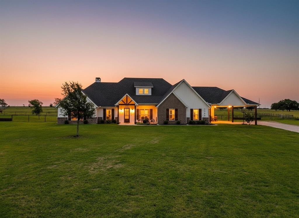 Welcome to your own slice of Texas country living! Nestled at the end of a peaceful cul-de-sac, this beautiful custom modern farmhouse offers the perfect blend of comfort, functionality, and wide-open space. Featuring a desirable split-bedroom floorplan with 4 bedrooms, 2.5 bathrooms, and an open-concept design, this home was built for both everyday living and entertaining.
The spacious living area is anchored by a cozy wood-burning fireplace and flows seamlessly into the kitchen and dining spaces, creating the perfect gathering place for family and friends. The thoughtfully designed layout provides privacy for the primary suite while offering plenty of room for everyone.
Outside is where this property truly shines. Situated on beautiful cross-fenced acreage with top rail pipe fencing, this property is ready for your horses and country lifestyle dreams. The horse area already features water access and is set up for convenience and functionality. Looking to add a future shop or barn? Electrical has already been stubbed out, making expansion easy.
Additional features include a spacious 3-car garage plus an attached 3-car carport offering abundant parking for vehicles, trailers, boats, or equipment. Enjoy peaceful evenings under the extended covered patio while taking in the wide Texas skies and scenic views.
If you’ve been searching for modern farmhouse charm, horse-ready acreage, and room to grow, this Poolville property checks all the boxes.
