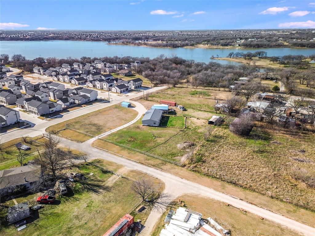 Endless possibilities!!! Residential, Commercial or Multifamily. Lot is currently not zoned for residential or commercial use, so there are no zoning restrictions. Build your dream home on this almost 1 acre lot in Little Elm, walking distance from the lake! It is in the ETJ, outside city limits so another option is multifamily or townhomes since this is in the ETJ. We have a rough rendition for 6-11 Townhomes, with builders in place to start building if the buyer would like to go that route. This information can be shared. Everything is subject to county approval. Please reach out to Denton County Development Services to confirm this information or Denton County Fire Marshall. Additionally, the fence partially extends over the neighboring property line, refer to the survey.