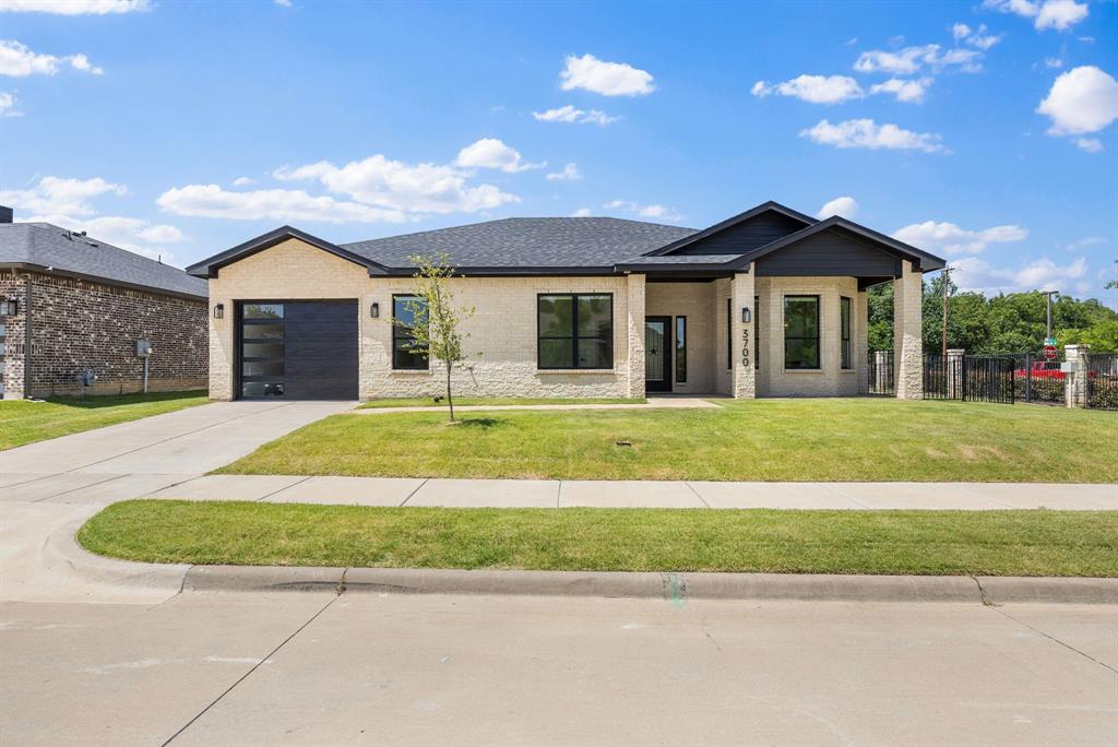 Experience luxury, comfort, and low-maintenance living in this exceptional one-story model home located within a premier 55+ active adult community in McKinney. Extensive custom upgrades and premium finishes throughout, this beautifully designed residence offers 3 beds, 2 baths, and an open-concept floor plan that brings everyday functionality. Positioned on a desirable oversized corner lot, the home also features a spacious backyard and covered patio ideal for relaxing. Experience the soaring ceilings, abundant natural light, decorative designer lighting, and luxury waterproof flooring that flows seamlessly throughout the home. The gourmet kitchen features elegant quartz countertops, upgraded shaker cabinetry, premium KitchenAid stainless steel appliances, and a luxury smart sink complete with a digital display, waterfall feature, pull-down faucet, and built-in accessories. The living room is anchored by a stunning 42-inch gas fireplace with remote control. The primary suite provides the perfect retreat, while both bathrooms feature floor-to-ceiling tile, premium matte black fixtures, accessibility grab bars, and luxury smart toilets with built-in bidets, heated seats, automatic flushing, and sleek tankless designs. Additional premium features include custom black-framed windows, upgraded window coverings, smart locks on all exterior doors, upgraded garage door, and a well-appointed utility room complete with a built-in sink. As the original model home, every detail was carefully selected to showcase superior craftsmanship and elevated design rarely found in standard new construction. Residents of this sought-after 55+ community enjoy a peaceful lifestyle with thoughtfully designed homes and amenities, all while being conveniently located near shopping, dining, healthcare, and everything McKinney has to offer. Complete with manufacturer warranties and a five-year slab foundation warranty, this extraordinary home is truly move-in ready and built to impress.