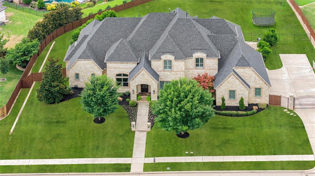 Located in the highly sought-after Clariden Ranch community in Southlake, 405 Mesa Ranch Ct is a truly one-of-a-kind estate offering the perfect balance of luxury, comfort, and lifestyle. Positioned on a quiet interior cul-de-sac and set on a sprawling .69-acre lot, this home enjoys an unbeatable location just moments from Bob Jones Park and Lake Grapevine—providing access to miles of trails, nature, and outdoor recreation. Inside, the home is designed for both grand entertaining and everyday living. The great room concept anchors the home, featuring an expansive kitchen that opens seamlessly to an oversized family room, all overlooking the stunning backyard. Walls of windows flood the space with natural light and frame incredible views, creating a warm yet sophisticated atmosphere. This thoughtfully designed floorplan includes 5 spacious bedrooms, each with its own ensuite bath, ensuring ultimate privacy and comfort. The primary suite offers a spa-like retreat, while additional living spaces include a secondary first-floor living area and an impressive game and media room—ideal for entertaining or relaxing. Step outside to experience resort-style living. The backyard is an entertainer’s dream with a Claffey-designed pool featuring diving capability, water features, and firepit, along with a fully equipped outdoor kitchen and BBQ area. The setting offers endless views and complete tranquility, making it the perfect backdrop for gatherings or quiet evenings. Additional highlights include an oversized 3-car garage, Generac generator, security system, and abundant storage. With the added benefit of open enrollment to Carroll ISD or Northwest ISD, this home combines luxury with flexibility. A rare opportunity in Clariden Ranch—where location, design, and lifestyle come together to create something truly exceptional.