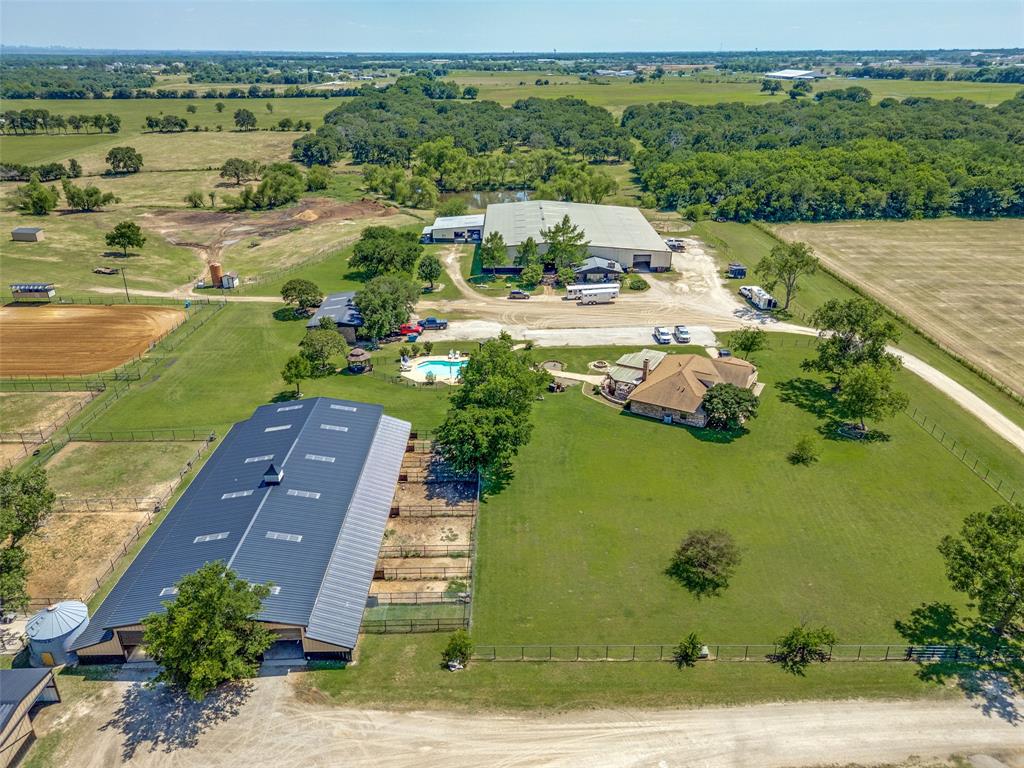 A turnkey equestrian property offered as either 27 acres, 18+- acres with residences and improvements, or 9+- acres of pasture overlooking a pond. See the map attached in the document section of this page.

This property presents a rare opportunity to purchase a turnkey equestrian boarding and training facility with income producing potential. The ranch features four barns with a total of sixty-five available stalls, indoor and outdoor arenas, equipment-storage barns, cattle chutes, turnouts, wooded pastures, pipe fencing, and six residences including a main house with swimming pool. The surrounding area is internationally renowned for training and breeding horse farms. There are numerous vets, farriers, and trainers in the immediate area for a variety of styles including cutting, reigning, reigning cow, hunter-jumper, dressage, polo, team roping, halter, thoroughbred, western pleasure, or barrel racing to name a few. The main house was originally built in 1981 as a club house for the ranch and overlooks a swimming pool and patio and cabana area for entertaining. Other residences on the ranch include two apartments within the main barn, and an attached cabin measuring roughly 1,300 sf. A mobile home and double wide, located near the north entrance of the property, are ideal for staff housing or for rentals.