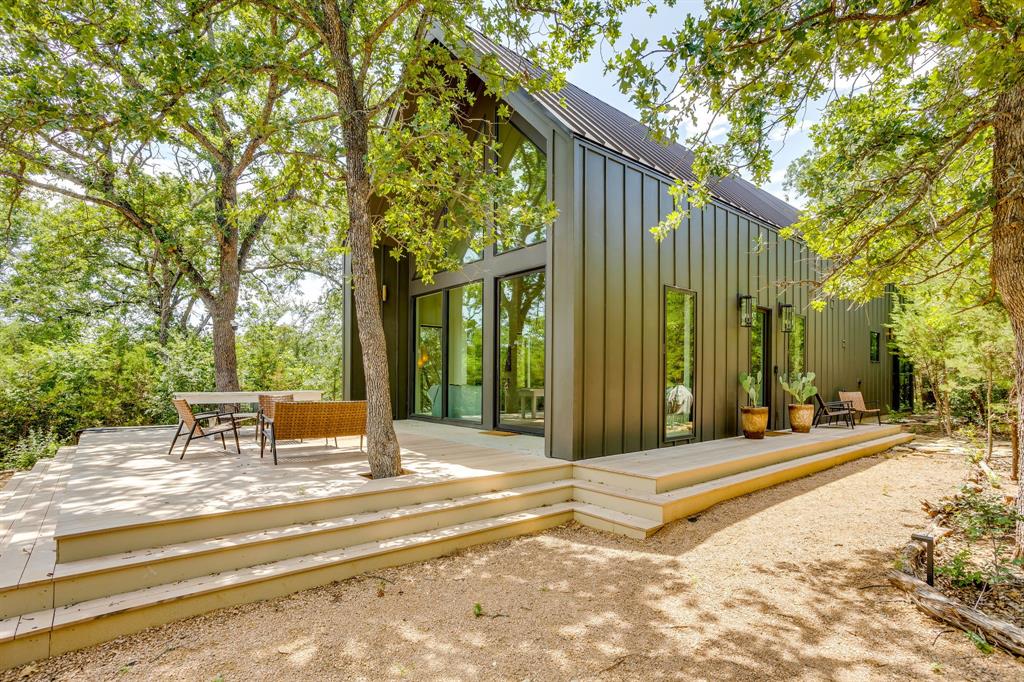 Tucked away on 30 private acres along the Brazos River, this fully off the grid retreat offers the kind of setting that’s increasingly hard to find — peaceful, secluded, and deeply connected to nature, yet still within easy reach of Granbury and Fort Worth.

With over 400 feet of river frontage, mature hardwoods, a wet-weather creek with natural waterfall features, and miles of trails to explore, the property feels like a true retreat. Whether it’s kayaking on the Brazos, quiet mornings outside, evenings around the firepit, or hosting family and friends for the weekend, this is a place designed to be experienced.

The home itself blends modern comfort with a warm, elevated cabin aesthetic. Thoughtfully designed for gathering, it features multiple sleeping areas, inviting indoor-outdoor spaces, and a layout that comfortably accommodates large groups while still feeling intimate and relaxed.

Currently operating as a successful short-term rental, the property offers flexibility as a private residence, weekend escape, investment opportunity, or legacy-style family retreat.

Rarely does a property combine this level of privacy, usability, natural beauty, and accessibility — all just 15 minutes from the Granbury Square.