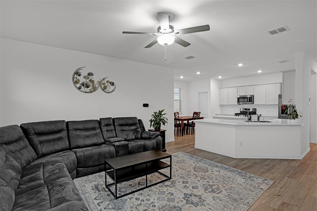 Great opportunity to own a newer home in North McKinney, one of the area’s fastest-growing communities! As you enter, you’re welcomed by a wide, extended hallway showcasing beautiful LVP flooring that sets the tone for the rest of the home. Two secondary bedrooms and a full bath are located to the left, while a third bedroom sits to the right. A formal dining area and the private primary suite are tucked away on the left side of the home, offering both functionality and privacy. The bright, open-concept kitchen, living, and breakfast areas are ideal for everyday living and entertaining. The modern kitchen features stunning quartz countertops and crisp white cabinetry, creating a clean and timeless look. Step outside to the covered patio and enjoy a large, private backyard ready for you to design your own relaxing outdoor oasis. The Reserve at Honey Creek offers resort-style amenities including a community pool with a lazy river and slides, along with parks, playgrounds, and scenic walking trails. This is a wonderful place to call home as the area continues to grow year after year!