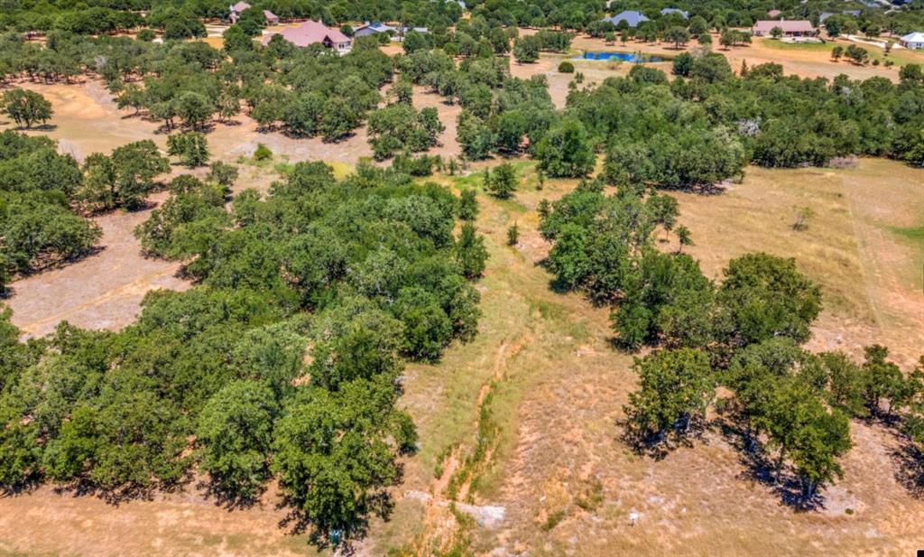 BROCK ISD with Golf Course Living!!! One of the last remaining lots with acreage in Sugartree on the Brazos. This 3.26 acre lot already has a water tap and is ready for you to build your custom home in the Sugartree subdivision. Located in Brock ISD - this community offers the best of both worlds. Whether you are an avid golfer or looking for a nice neighborhood, Sugartree is the perfect place to call home. Enjoy the community amenities that include a swimming pool, community center, restaurant and the SugarTree Championship Golf Course. Bring your Builder or choose from a list of Select Builders. Enjoy a beautiful country setting only minutes from Ft. Worth.