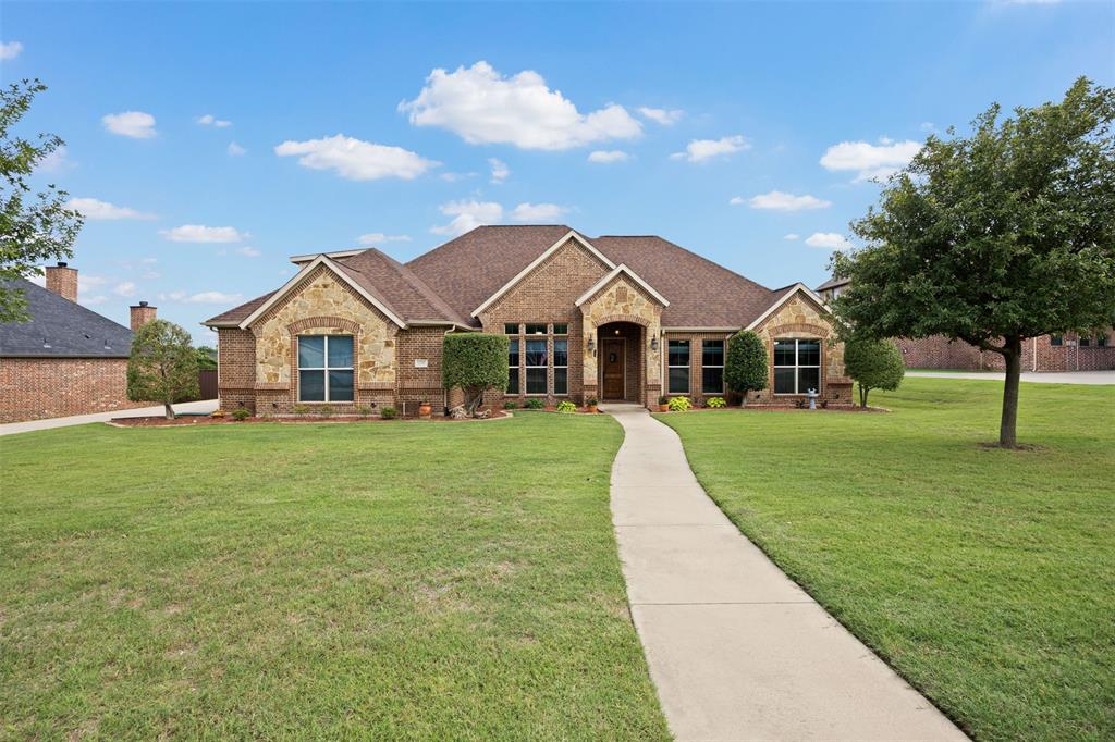 Welcome to 8230 Glenwick Drive — Luxury Living in the Heart of Glen Highlands. Tucked inside one of Waxahachie's most sought-after gated communities, this home was built and maintained with pride on a beautifully landscaped 2,847 sft stunning 4-bedroom, 3-full bathroom 3 car oversized garage with wonderful flex space upstaris all sits on .6 acre lot. This home has the perfect blend of private, prestigious and peaceful setting that you might be looking for. Waxahachie address that is outside city limits, has an hoa and is in top-rated Midlothian schools, Walnut Grove Middle and Heritage High (rated A). 

Tired of an all white home and want the look and feel of stunning stonework and deep rich wood and tones? You'll found it as soon as you enter you'll feel the richness from the hand-scraped real hardwood floors, the beautiful ceiling woodwork in the dining room-that could also be an office, along with the kitchen cabinets that reach the top of the ceiling. The stonework shows with the kitchen island, indoor and outdoor fireplaces. The open floor plan flows effortlessly from the living room to the dining area and into a chef's kitchen outfitted with granite countertops, a center island, with the kitchen sink island with all the built in appliances that include a double oven.

There's the flexibility with the upstairs to fit your needs. It has huge space with a full bathroom and closet so if you need an in-law space, teenager that wants a little freedom or just use as an entertainment area this is all up to you. Room dimensions are listed on the floor plan. Put this home on your list to see.