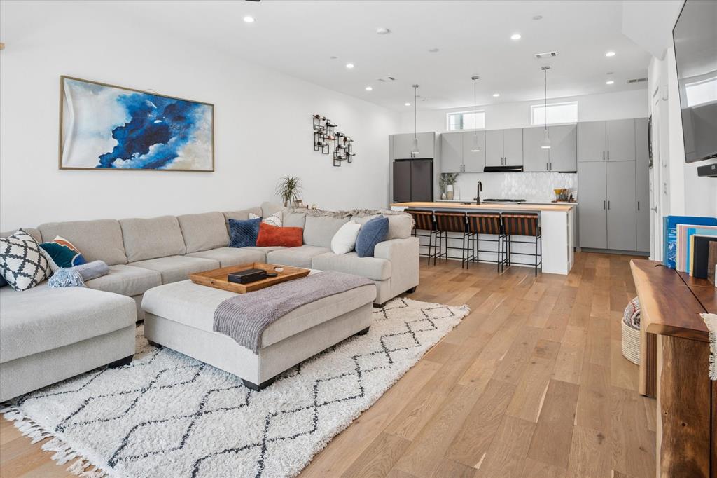 Located in the coveted Bishop Arts District—one of Dallas’ top 3 most walkable neighborhoods—this like-new contemporary townhome offers luxury city living just 10 minutes from Downtown. Boasting four levels of thoughtfully designed space, high ceilings, hardwood flooring throughout (no carpet) and integrated smart thermostats. This home balances vibrant urban convenience with premium design, privacy and exceptional investment potential. Walk to over 60 independent boutique shops, specialty workout studios, Michelin-recommended restaurants, coffeehouses, live music, and art galleries. Minutes from Kidd Springs Park, Trinity Groves, I-30, and I-35.
THE FOUR-LEVEL LAYOUT:
• First Level: A landscaped front yard with grass leads to a welcoming entry equipped with a smart door lock and a rare, private two-car garage with a Wi-Fi enabled door. (custom fencing project is currently underway at no additional cost to the buyer)
• Second Level (Living & Entertaining): An expansive open-concept environment flooded with natural light from oversized windows. Features a gorgeous chef's kitchen centered around a massive butcher block island and a premium Fisher & Paykel and KitchenAid stainless appliance package with a gas range. The living area opens to a private balcony overlooking the historic neighborhood.
• Third Level (Private Rest): A dedicated floor entirely for the primary suite. Includes a large walk-in closet and a relaxation-inspiring spa shower featuring a built-in soaking tub. The laundry room is also conveniently located on this level alongside the included washer and dryer.
• Fourth Level (Guest Retreat & Rooftop Deck): Features two additional guest bedrooms and a full guest bathroom, offering privacy and flexible space for a home office. This level opens directly onto an expansive, private rooftop deck - the perfect spot for enjoying starry nights in the city with downtown in the background.
Make this unique townhouse your home!