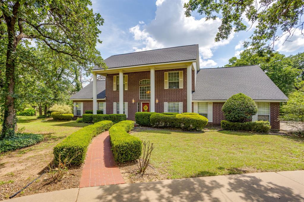 CHARMING two story Colonial style home nestled on nearly 6 acres of beautifully landscaped grounds with mature trees, offering the perfect blend of peaceful country living and everyday convenience. From the moment you enter, you’ll be welcomed by a soaring two story entryway and timeless architectural charm throughout. The spacious layout includes a formal dining room, inviting breakfast area, and a well appointed kitchen featuring stainless steel appliances, abundant counter space, and functionality ideal for everyday living and entertaining. A large laundry room with sink plus an additional flex space provides endless possibilities for a sewing room, home office, hobby room, or extra storage. The oversized primary suite offers a relaxing retreat with a spacious en suite bath complete with separate vanities, dual sinks, separate closets, a garden tub, and separate shower. The living room is filled with natural light from large windows and showcases beautiful built ins along with a cozy fireplace and mantle centerpiece. Upstairs, an open catwalk overlooks the main living area and leads to two secondary bedrooms and a full bath. Both secondary bedrooms feature generous walk in closets and are thoughtfully separated from the primary suite for added privacy. Outside, enjoy a tranquil backyard oasis with lush landscaping, mature shade trees, extended patio space perfect for entertaining, family gatherings, or simply relaxing in nature. Additional highlights include a three car garage and extra paved parking. Enjoy the serenity of country style living while remaining conveniently close to shopping, schools, dining, and entertainment.