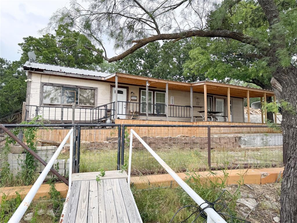 Unwind along the peaceful shores of Lake Cisco with this fantastic lake house, perfectly situated for relaxing days on the water and excellent fishing. This 1 bedroom, 1.5 bathroom retreat features a spacious living area large enough to accommodate twin beds or futons for overnight guests, making it perfect for weekend getaways and hosting family or friends. Spend your mornings enjoying coffee on the oversized deck overlooking the water while listening to the gentle waves roll in, or soak up the sunshine from the dock just steps away. Whether you’re searching for a relaxing escape or a fun gathering spot by the lake, this property is ready to make lasting memories.  This is a leasehold estate.