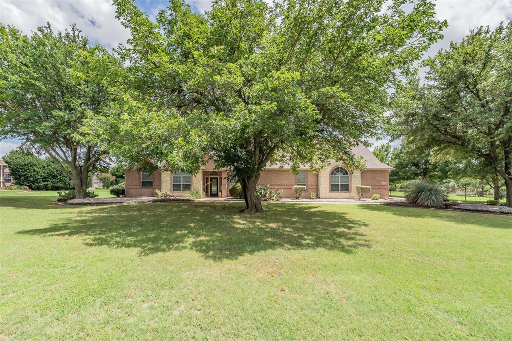 Beautiful Custom Built Home in the Highly Sought-After Gated Community of Van Zandt Farms.  Situated on a nicely manicured and partially fenced 1.12-acre lot, is this exceptional brick home offering the perfect blend of comfort, functionality, and outdoor living. Featuring 4 bedrooms, 2 full baths, and 1 half bath, a spacious 3 car garage, AND a detached pool house with additional living area and full bath.  This versatile floor plan offers many options for rooms and spaces to fit everyone's needs.  The heart of the home is the spacious family room with custom built-ins and a gas fireplace, conveniently located just off the kitchen which features an abundance of storage and Silestone and tile countertops, a center island, a pantry, and a breakfast dining area looking out to the backyard.  A more formal living and dining areas at the entry of the home provides additional space for entertaining, or gatherings. 
The split-bedroom layout affords privacy for the primary suite, which features a ensuite bath with a jetted garden tub, separate tiled shower, dual vanities, abundant counter space, and an oversized walk-in closet. Upstairs, the fourth bedroom or bonus room provides a private retreat with two large walk-in closets and direct access to a decked attic area, offering additional storage space  Step outside and enjoy your own backyard oasis. Outdoor amenities include a covered patio, fire pit, sparkling in-ground pool with water feature, and a detached pool or guest house with a full bath and AC.  The covered outdoor kitchen is ideal for entertaining and features a built-in grill, sink, refrigerator, bar seating, and storage closet for pool equipment. Residents of Van Zandt Farms enjoy community amenities, including a neighborhood swimming pool, covered cabana area, park and playground, scenic walking trails, and ponds. This remarkable property offers the ideal combination of luxury, flexibility, and resort-style living. Schedule your private showing today!