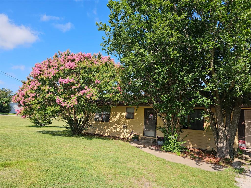 Charming, spacious and with a backyard oasis! This adorable home sits on an oversized corner lot with more than half an acre of space to enjoy! From the moment you step outside, you’ll fall in love with the incredible backyard retreat designed for relaxing, entertaining, and everyday living. Unwind on the covered back porch, gather with family and friends for summer BBQs, or enjoy peaceful evenings beside the beautiful goldfish pond with its soothing waterfall. The expansive yard offers endless opportunities for gardening, hobbies, and outdoor projects. Green thumbs will especially appreciate the established garden area and dedicated greenhouse along with a storage building perfect for lawn equipment, tools, outdoor gear, or recreational toys. Inside, the home features a welcoming open layout; a kitchen with abundant counter space, generous cabinet storage, and a dedicated dining area ideal for everyday meals or entertaining guests. Just off the kitchen is a convenient laundry space with room for a full-size washer and dryer. Bedrooms are spacious boasting large closets. The oversized two-car garage provides even more functionality with additional space for storage, tools, or a workshop area, plus two separate storage closets to keep everything organized. The garage sits on a slab foundation, while the home itself is pier and beam. If you’ve been looking for a property with charm, space, and a backyard oasis to truly enjoy, this one is a must see!