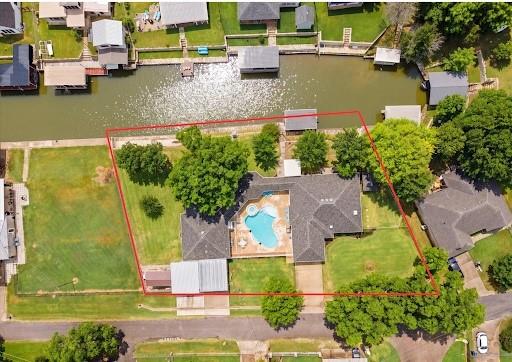 Waterfront Retreat with Guest House, Pool & Income Potential! Resort-Style Living in the Heart of Granbury! Welcome to 412 Mercury Court, a beautifully remodeled property offering the perfect blend of comfort, style, and space to entertain. Thoughtfully updated just two years ago with additional square footage added, the main home features a fresh, modern feel while still offering the warmth and functionality buyers love. Step outside and you’ll find your own private retreat with a sparkling pool, outdoor kitchen, and inviting backyard spaces designed for relaxing weekends, summer gatherings, and effortless entertaining.

One of the standout features is the well-finished guest house, ideal for extended family, visiting guests, a private office, hobby space, or multi-generational living. This additional guest home could also become a short term rental. With flexible living options, updated finishes, and exceptional outdoor amenities, this Granbury property delivers the lifestyle buyers are looking for — both inside and out.

412 Mercury Court isn’t just a home — it’s a place to gather, unwind, and enjoy the best of Texas living. Square Footage is approximate.